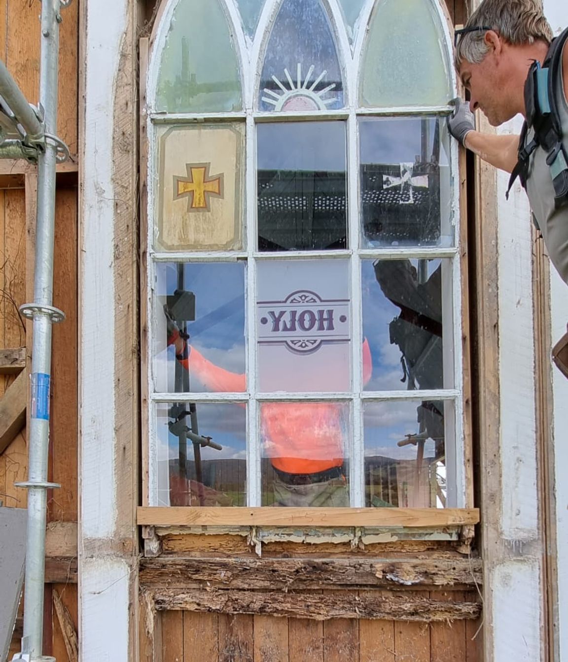 Revealing the rot and woodworm of the original window