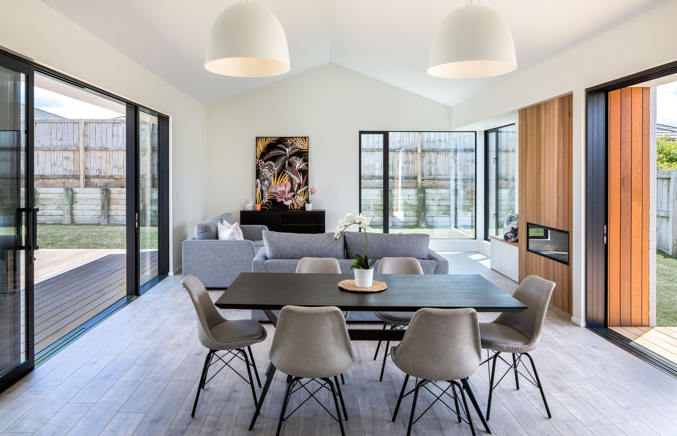 The dining and lounge areas share a cedar-clad fireplace.