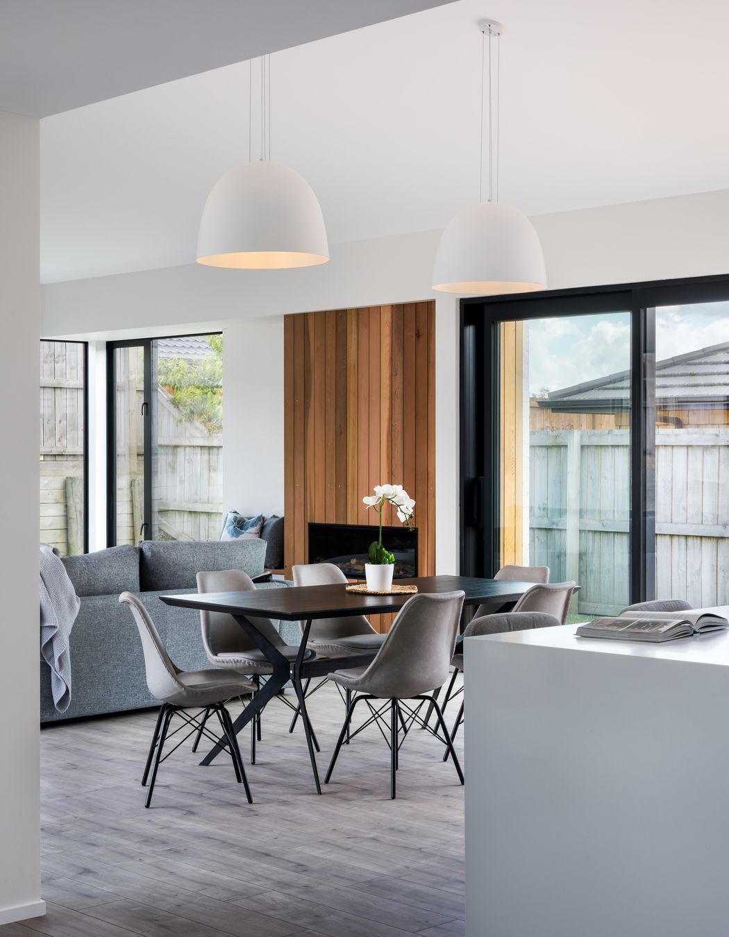 Dome pendant lights centre over the dining table.
