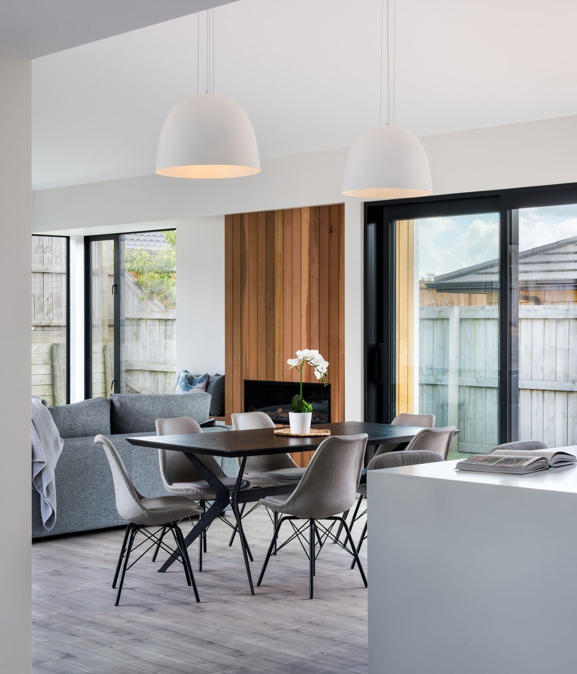 Dome pendant lights centre over the dining table.
