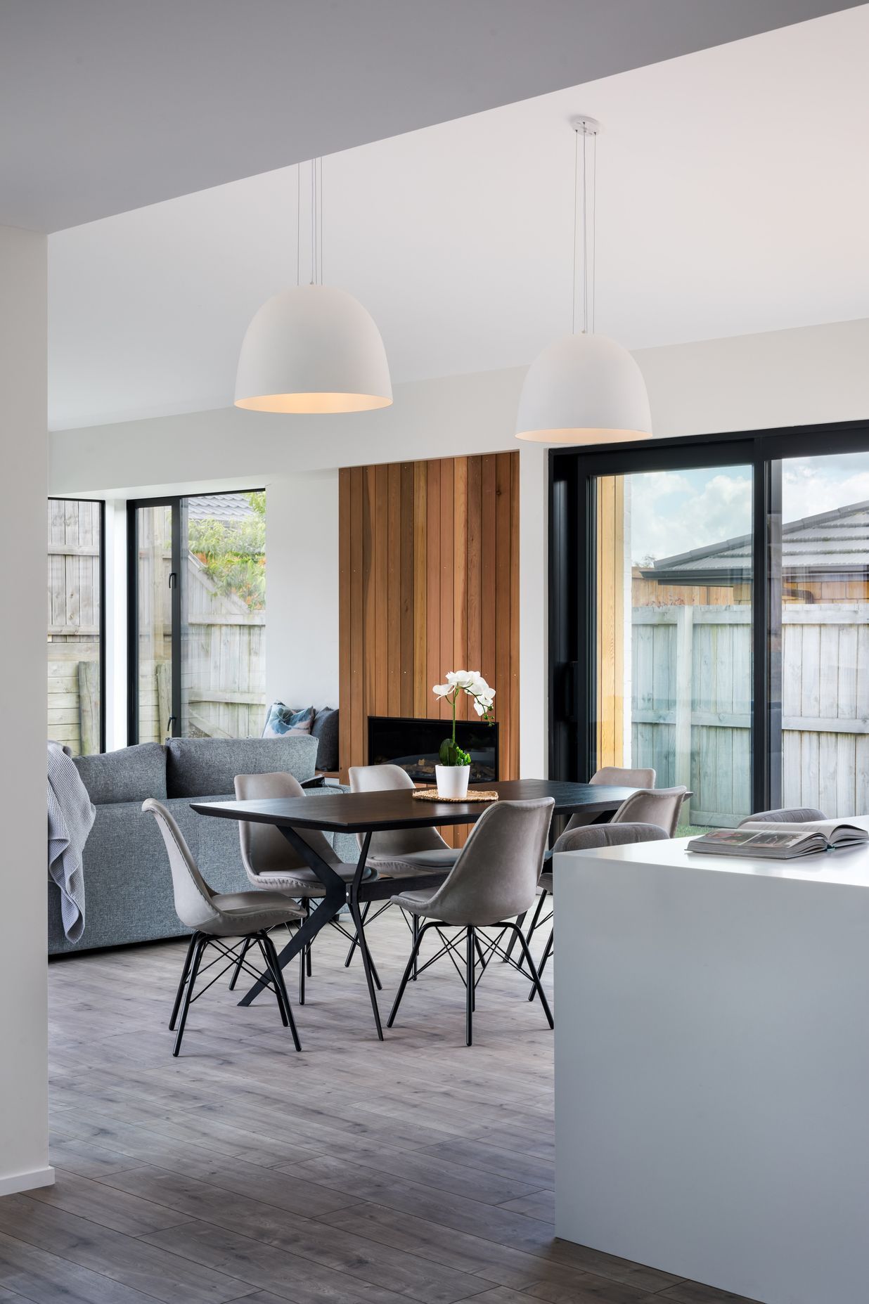 Dome pendant lights centre over the dining table.