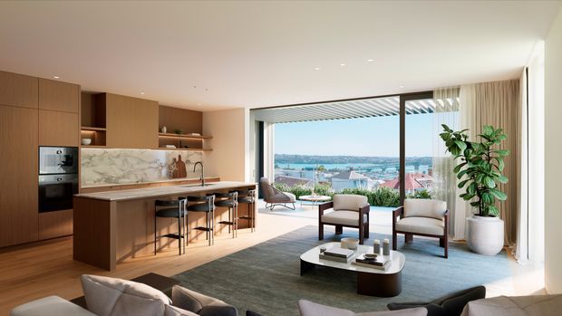 A bright, open-plan contemporary living and kitchen area with warm timber cabinetry, a marble-look island splashback and benchtop, integrated appliances, and bar seating. The living zone includes a large rug, low coffee table, armchairs, and a sofa, opening through expansive floor-to-ceiling glazing to a balcony or terrace with a broad waterfront or harbour outlook.
