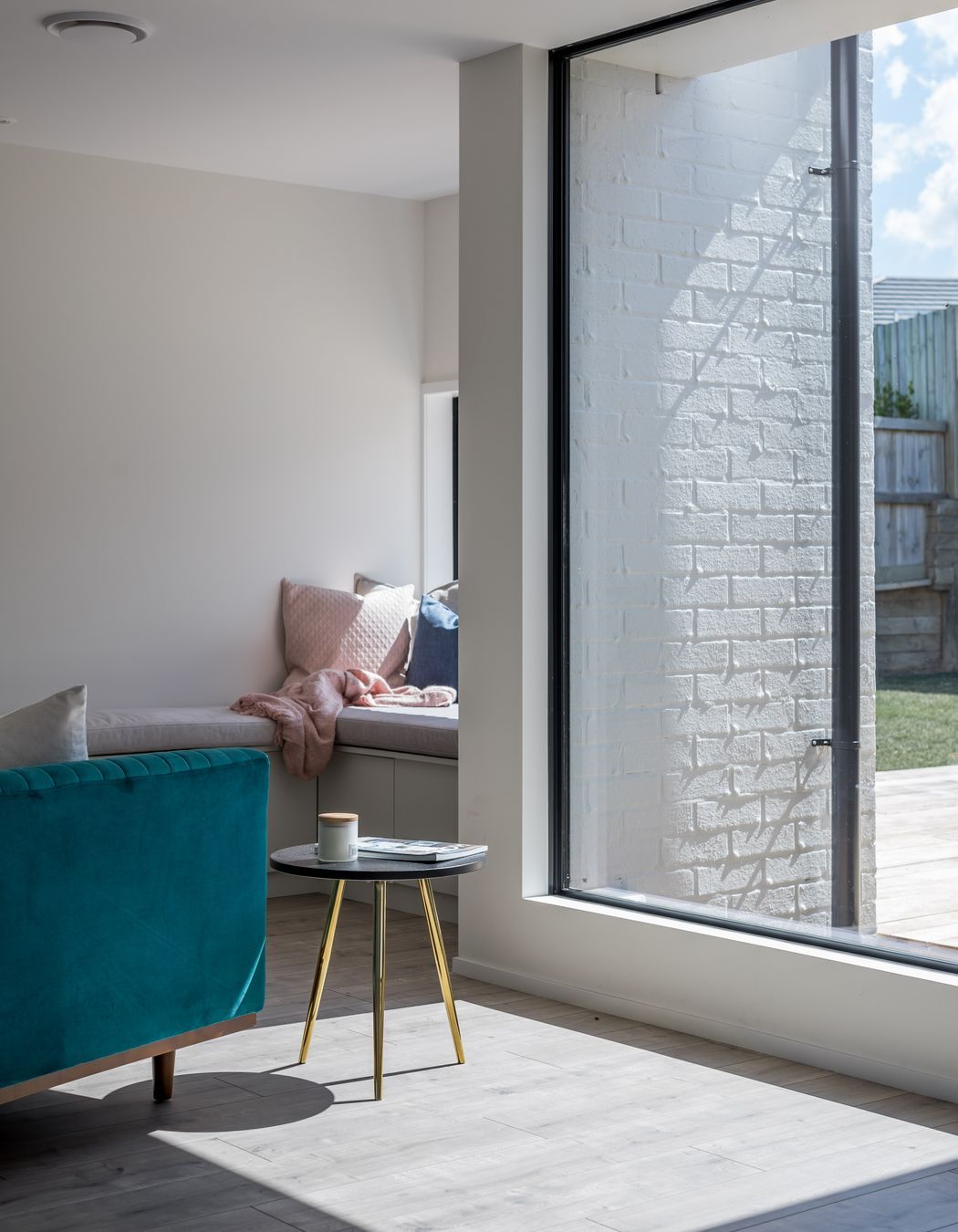A second sitting area with built-in seating is a quiet spot to relax.