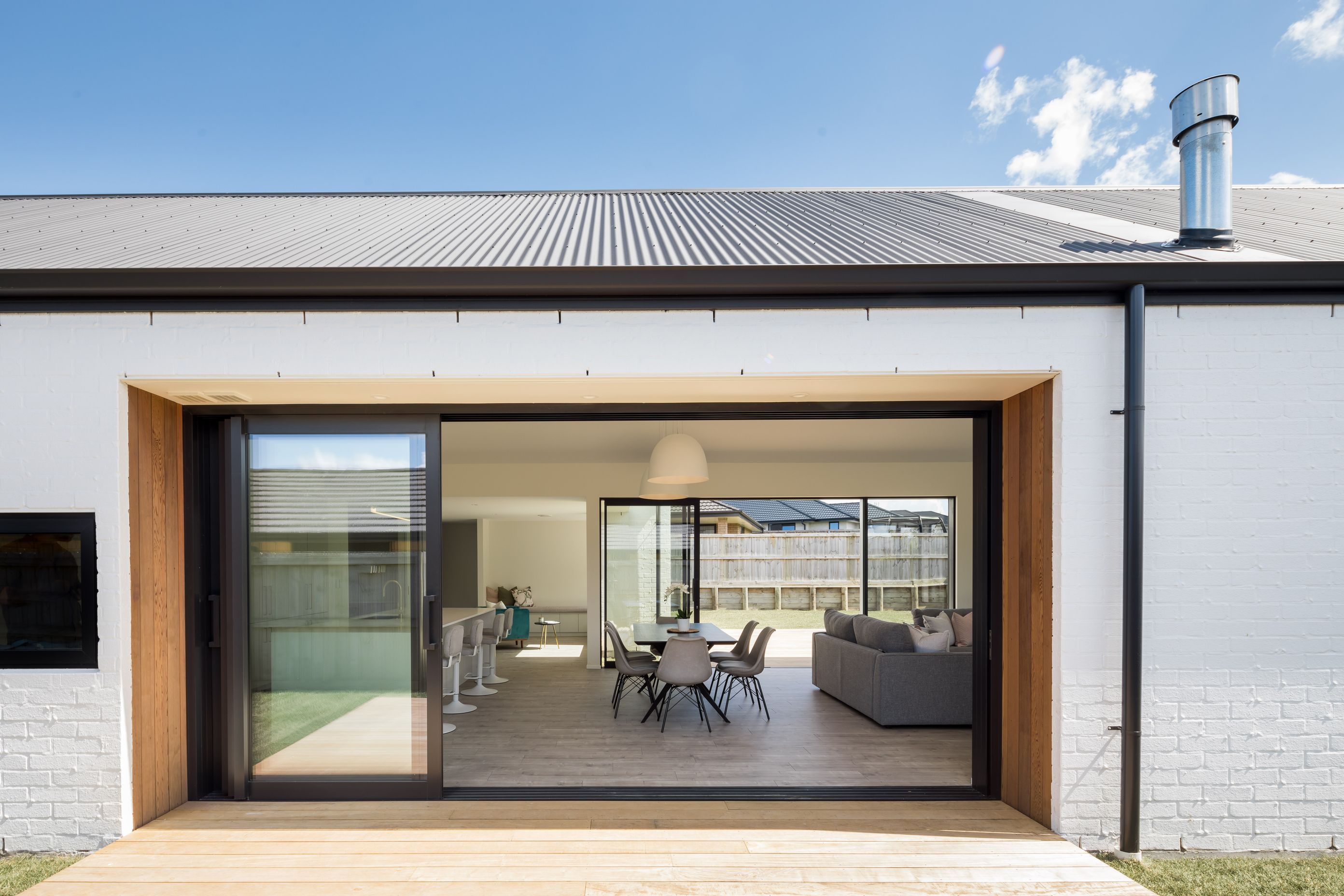 Large sliding glass doors create indoor-outdoor flow.