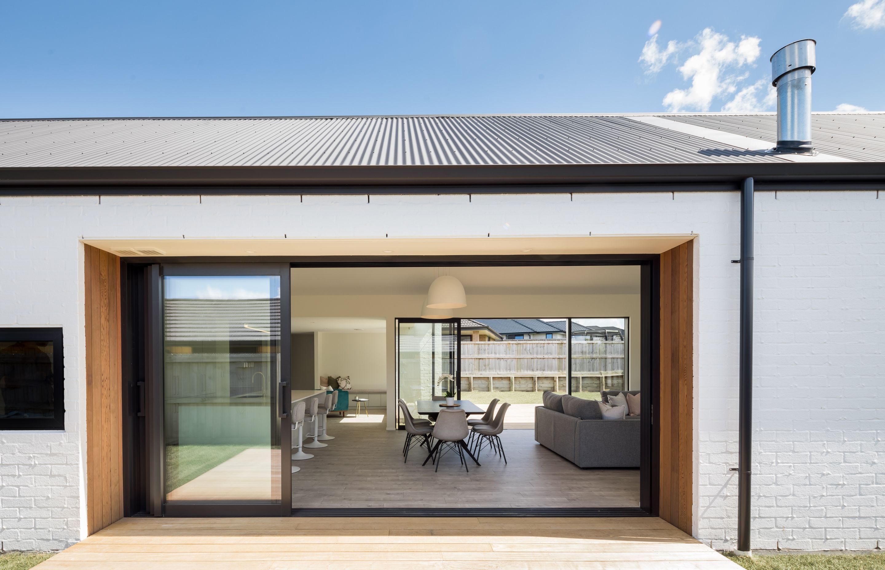 Large sliding glass doors create indoor-outdoor flow.