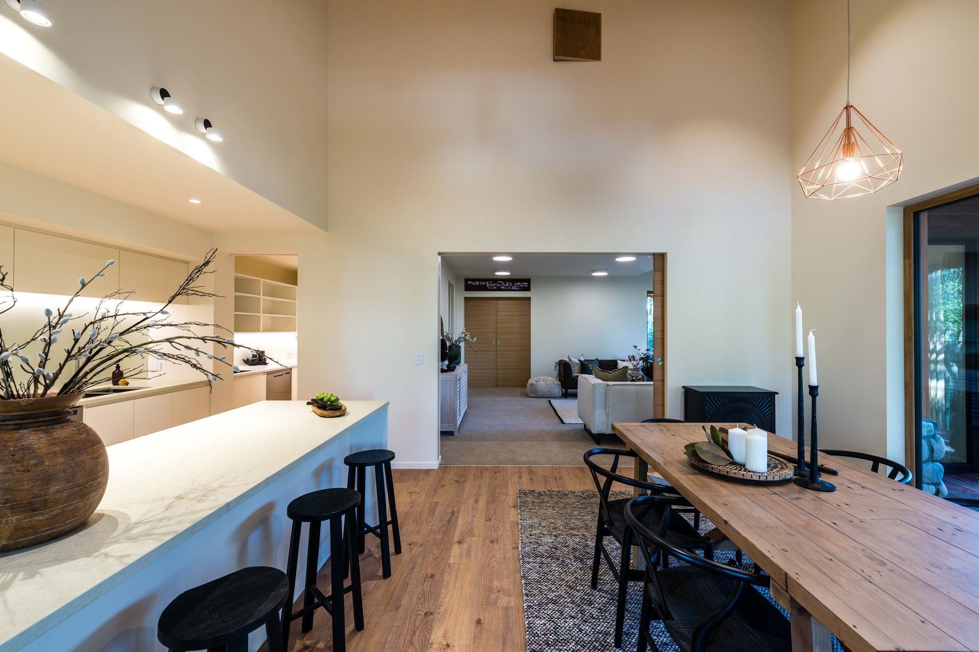 Kitchen dining looking towards the lounge. At the top is a butlers hatch connected to the upper level bedroom suite.
