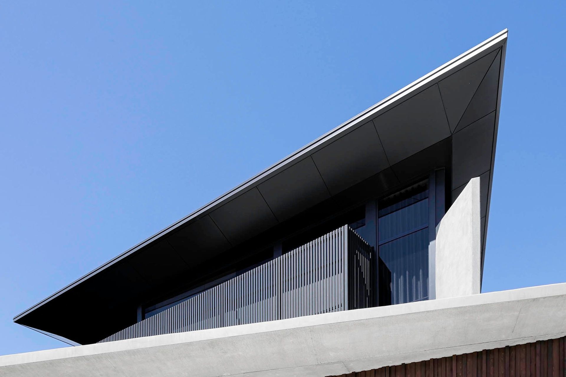 Robbie Residence - Exterior. Sharp angled roof edge against a blue sky.