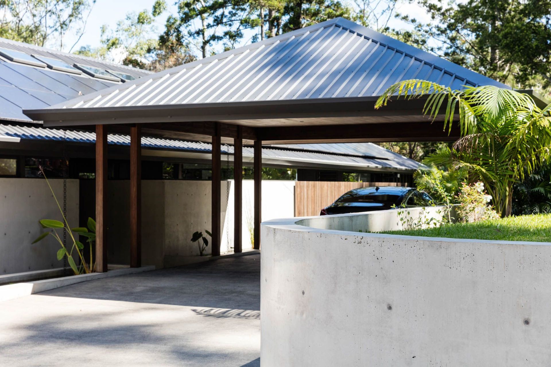 Watson Residence - Exterior. Hipped pavilion roof over the carport and entry.