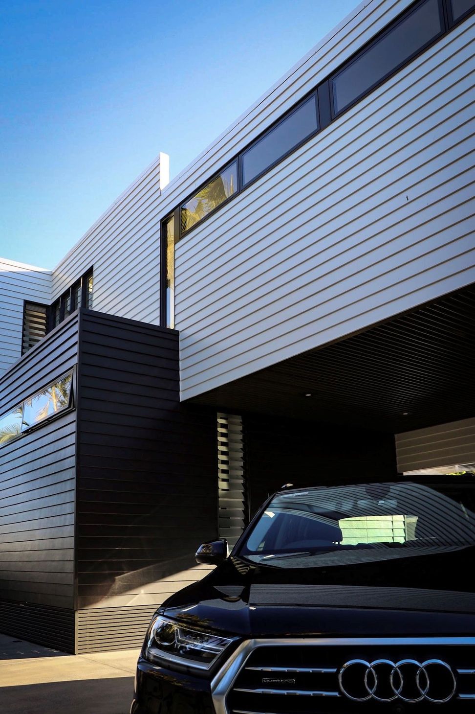 Kruger Residence - Exterior. Dark cladding and window hood details.
