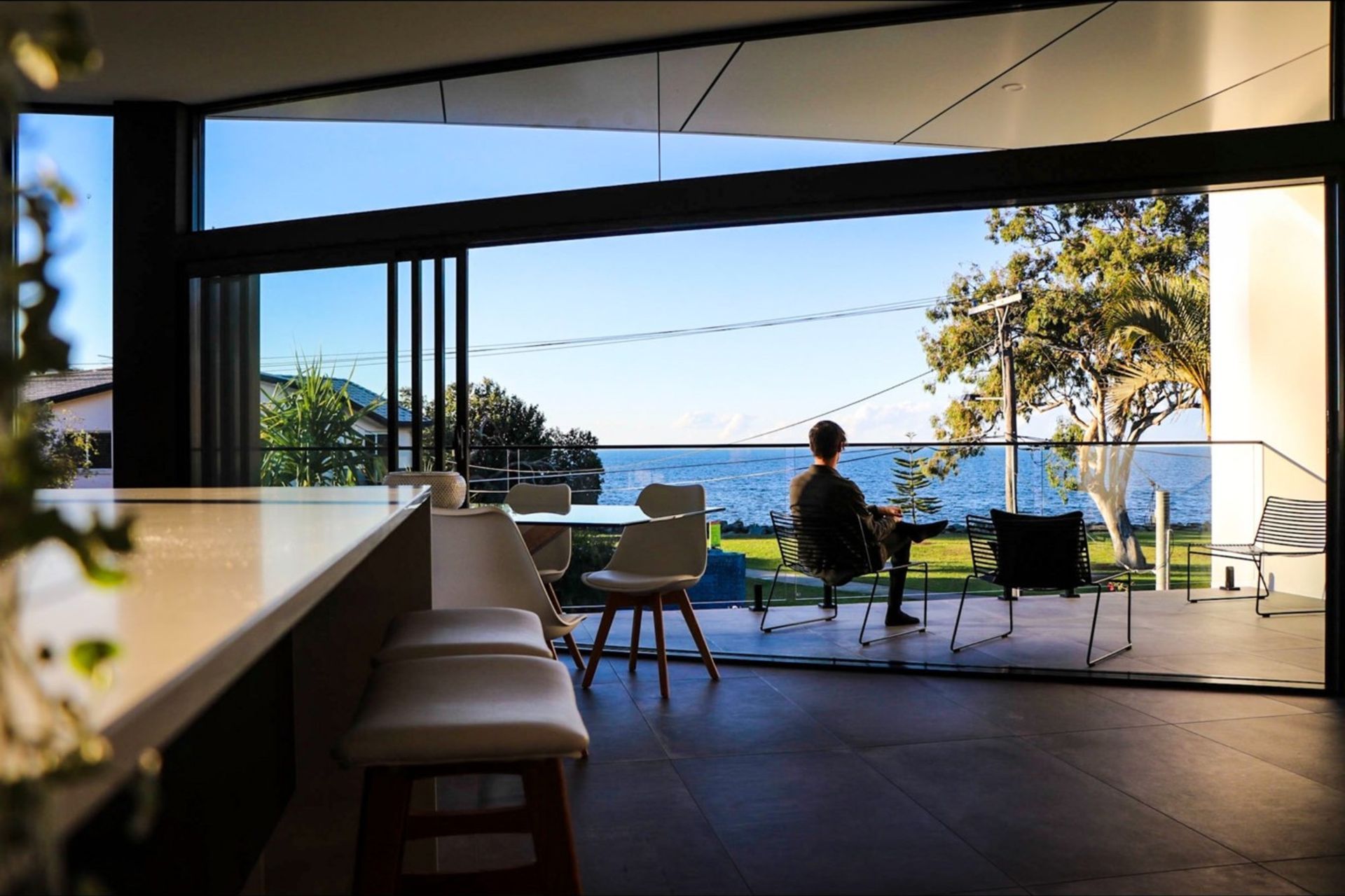 Kruger Residence - Kitchen. Kitchen bench and dining opening to the water view.