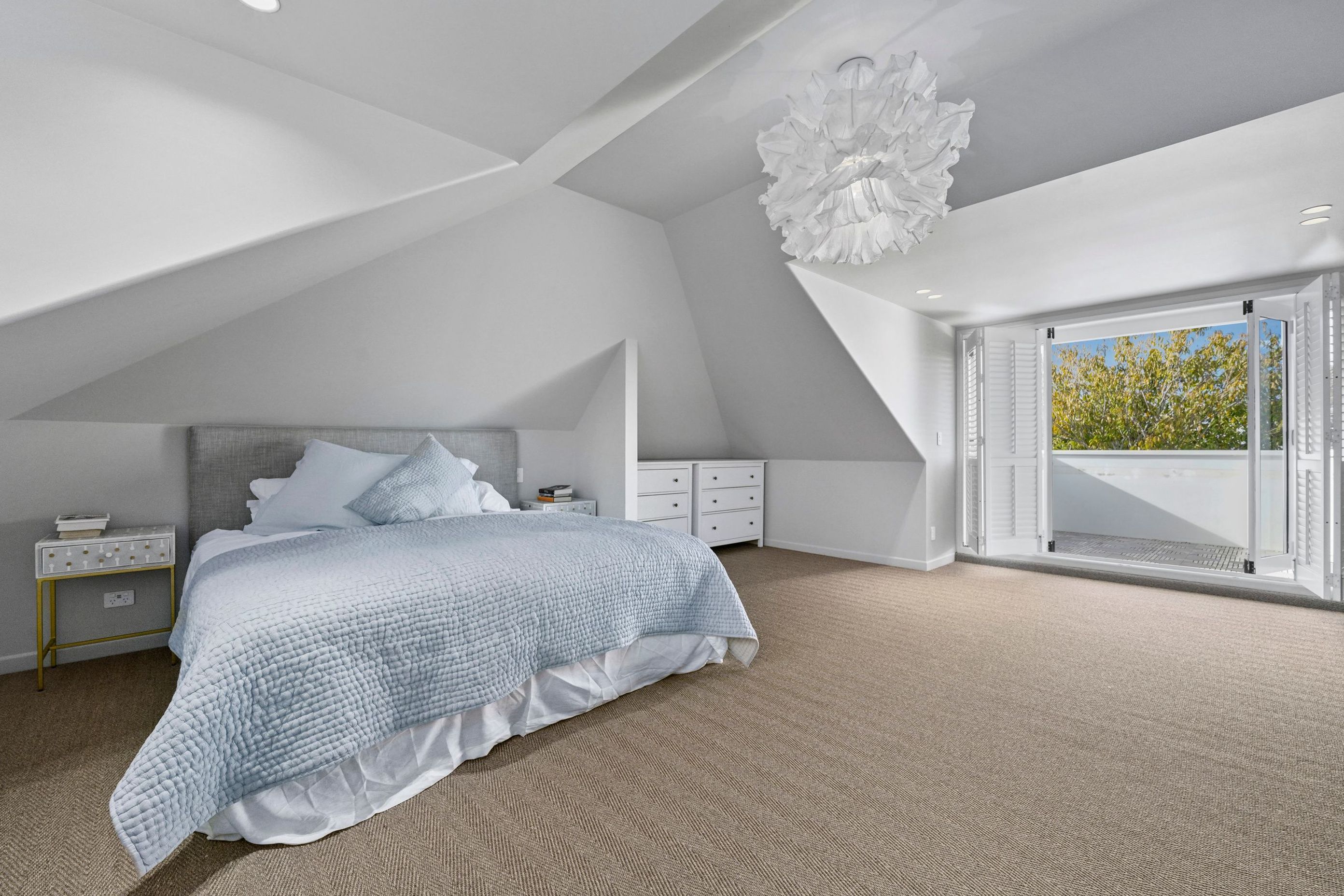 We carried the same finish through for a seamless feel. Flooring, paintwork, and lighting all work together to make this space feel restful and refined.