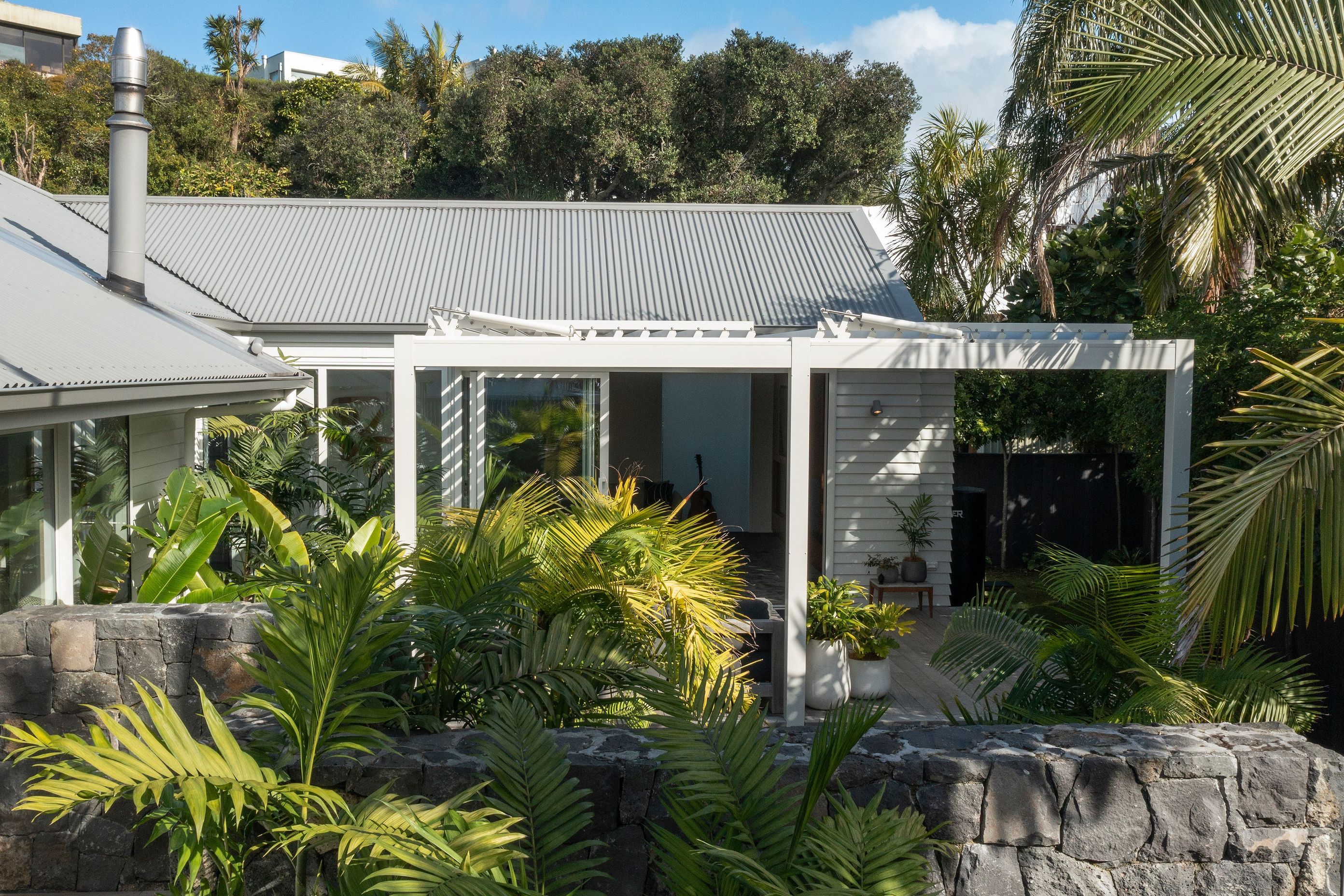 Auckland Home Project. Louvre Roof and Gate Create Oasis of Tranquility