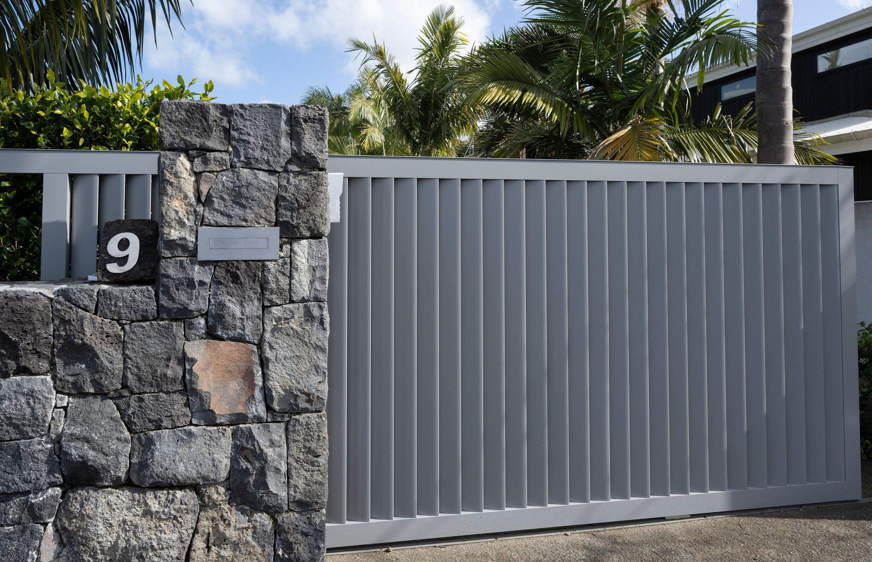 Auckland Home Project. Louvre Roof and Gate Create Oasis of Tranquility