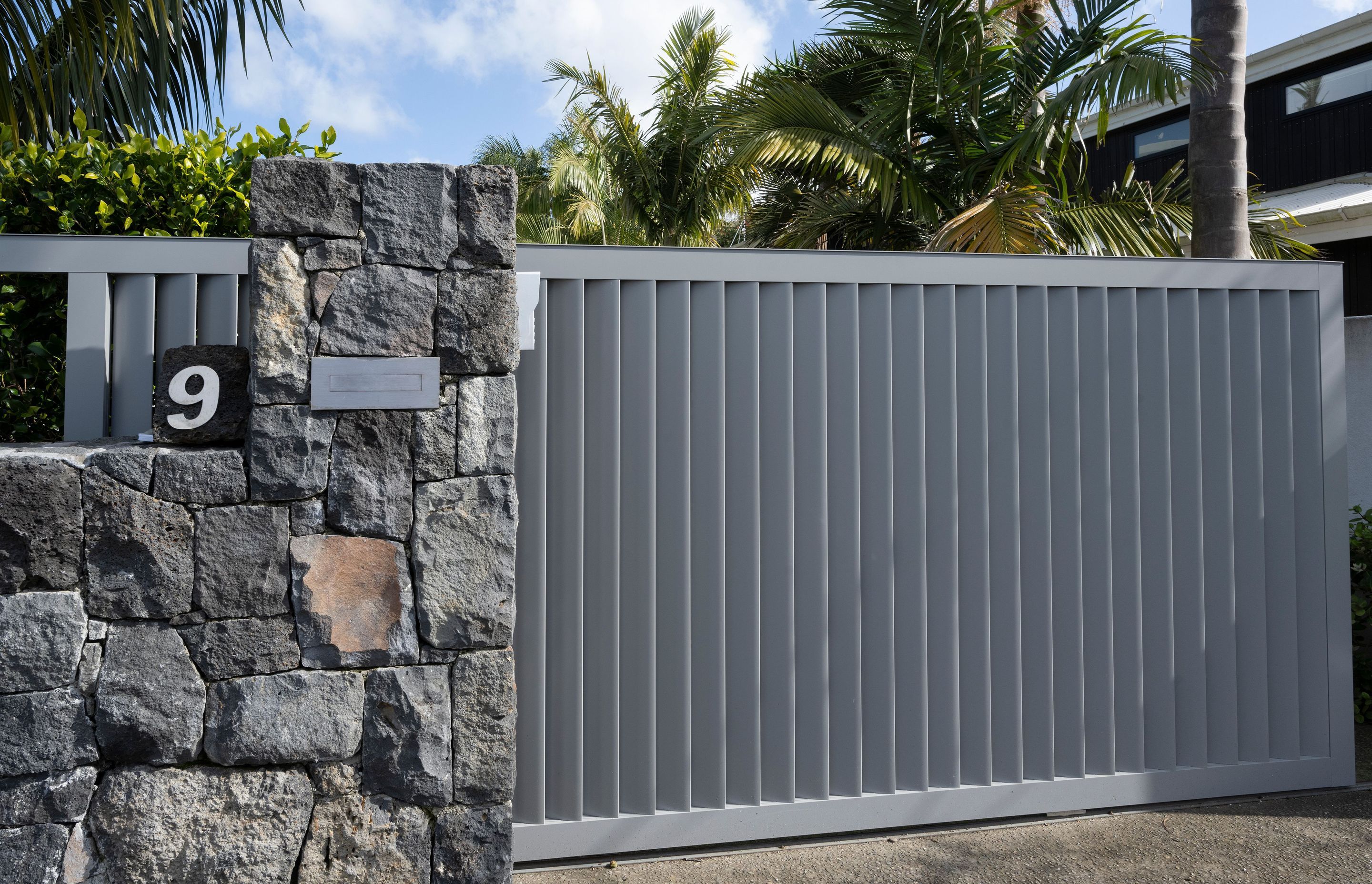 Auckland Home Project. Louvre Roof and Gate Create Oasis of Tranquility