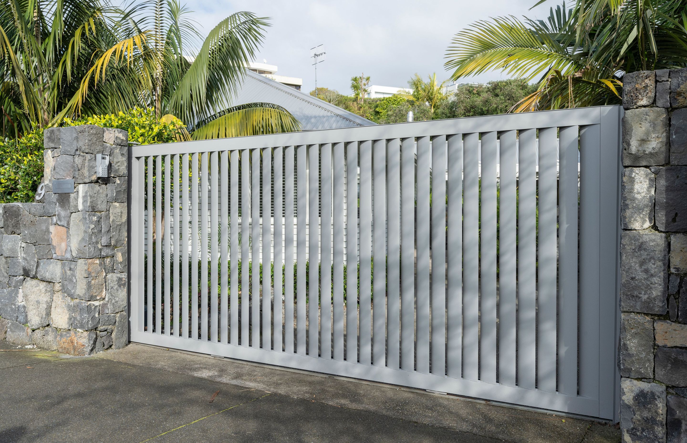 Auckland Home Project. Louvre Roof and Gate Create Oasis of Tranquility
