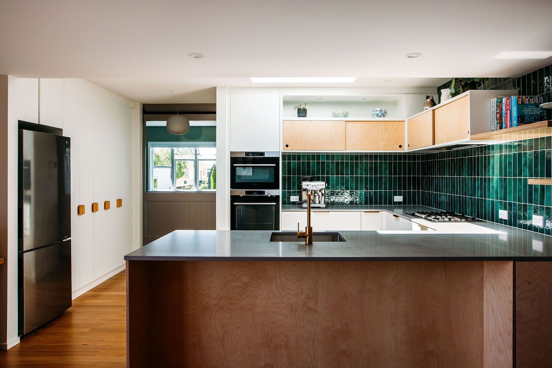 Ample pantry storage and fridge space on the adjacent wall.