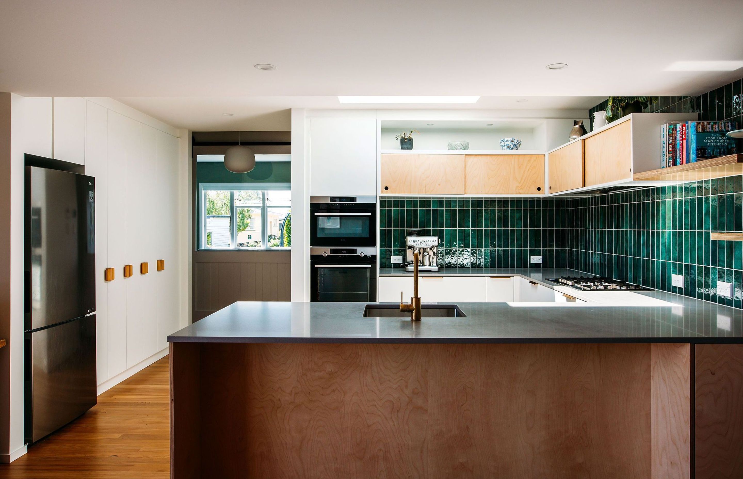 Ample pantry storage and fridge space on the adjacent wall.