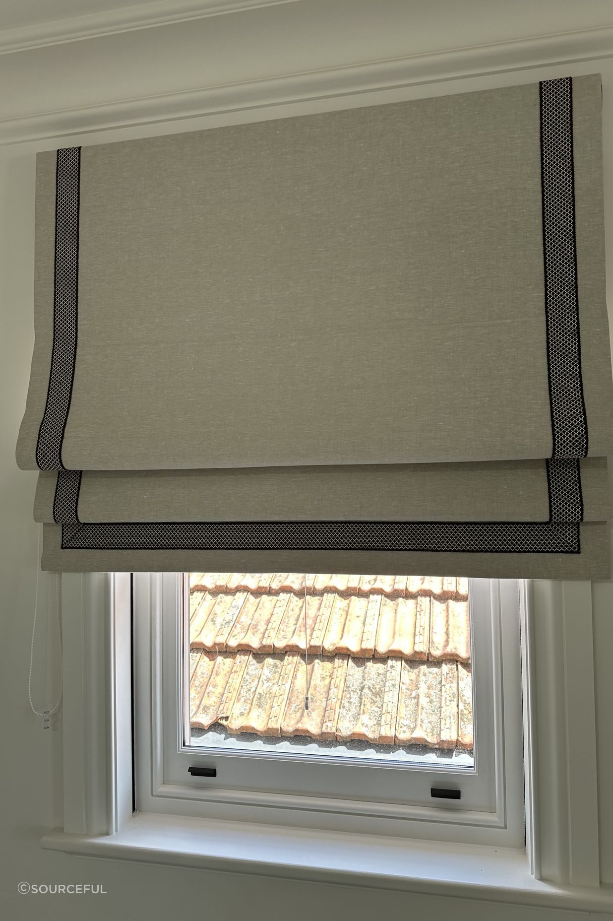 Lined roman blind with a contemporary accent tape to the edges.