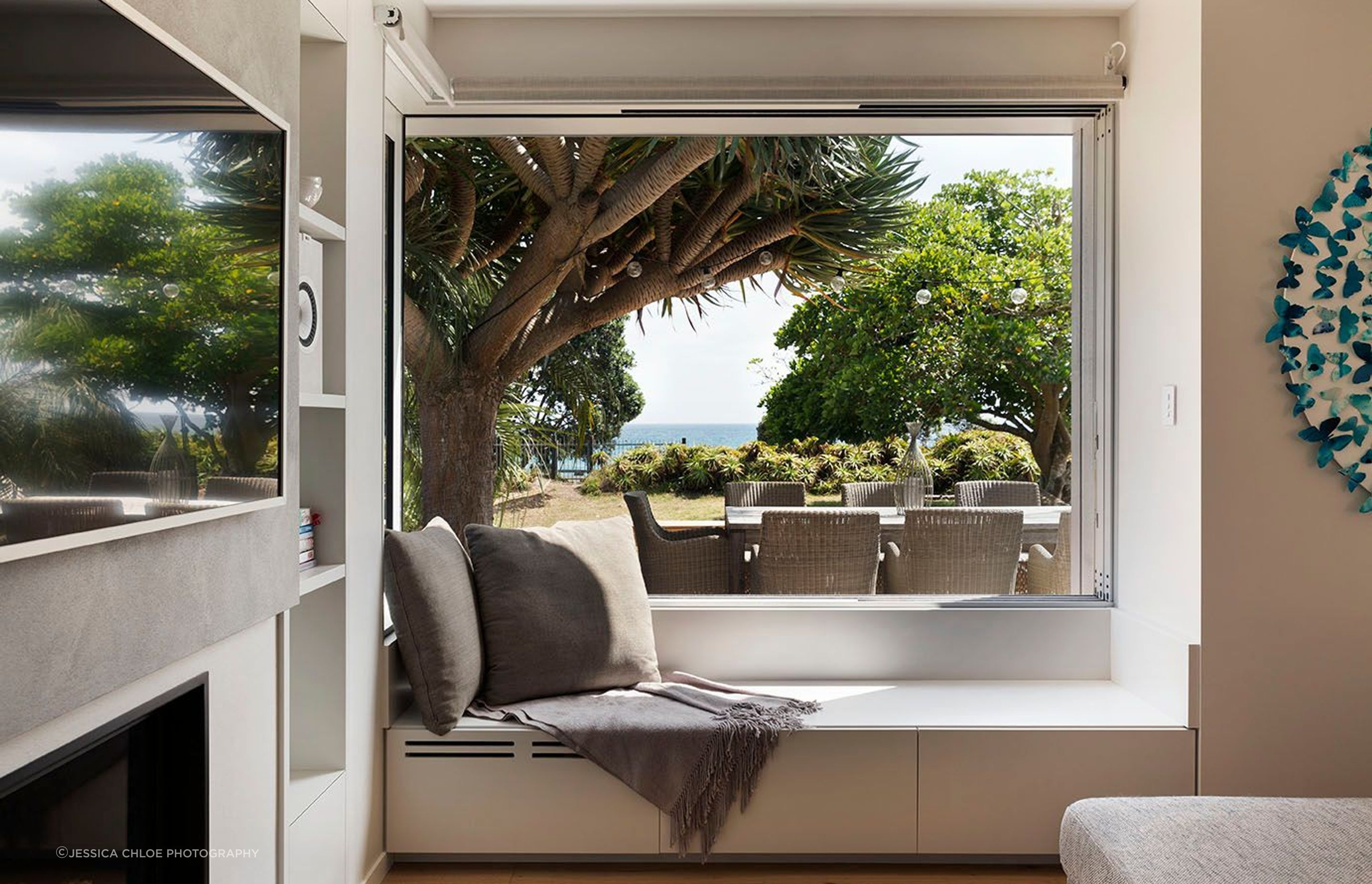 Corner window opens up flush with the wall to the stunning beachfront view and front yard