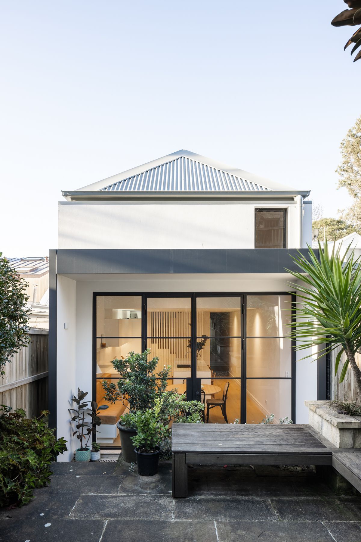 Sensitive rear extension with steel doors framing the interior and exterior spaces