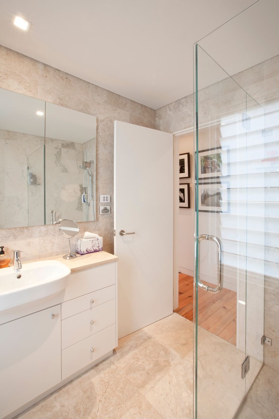 Fully tiled travertine ensuite with custom designed joinery