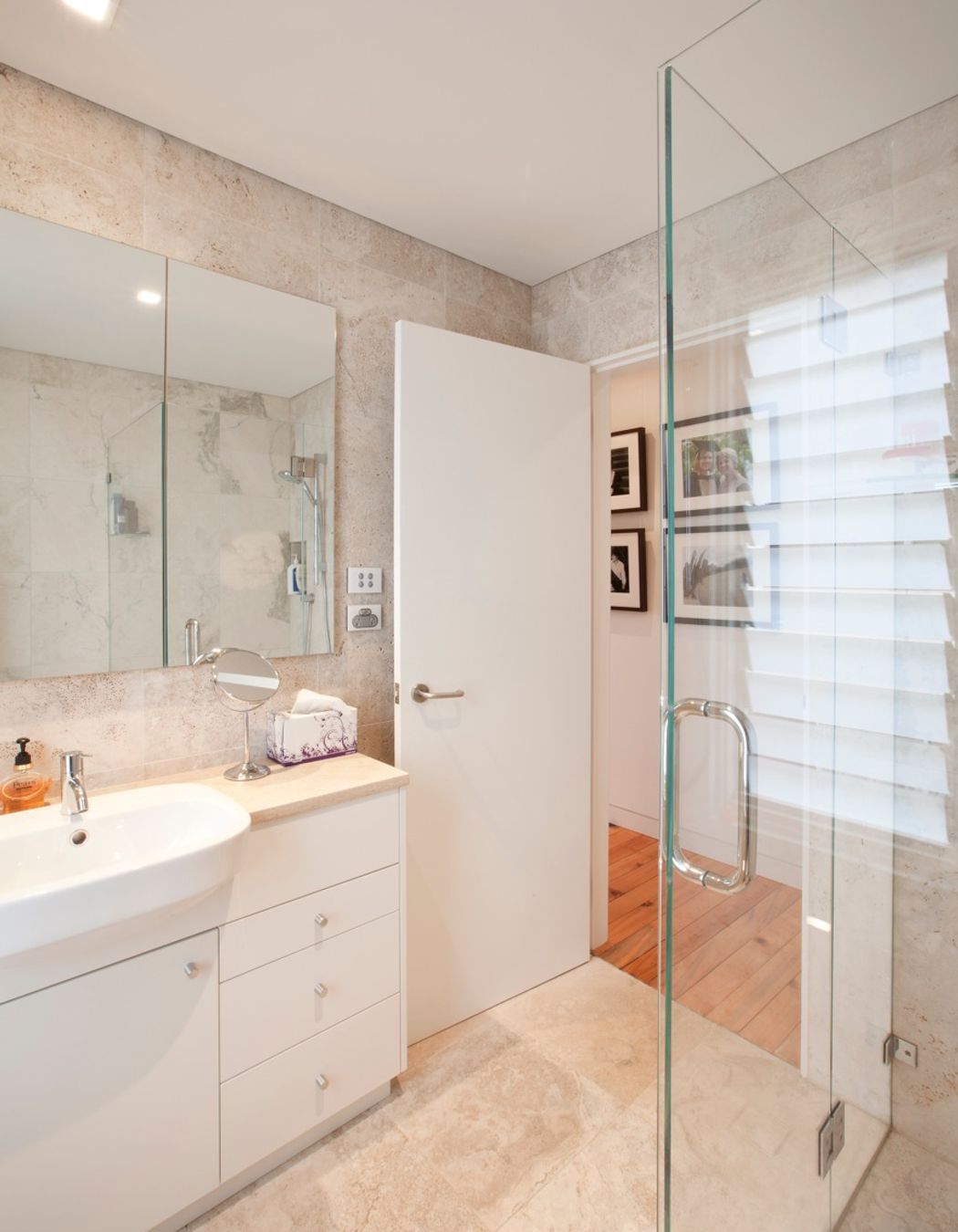 Fully tiled travertine ensuite with custom designed joinery