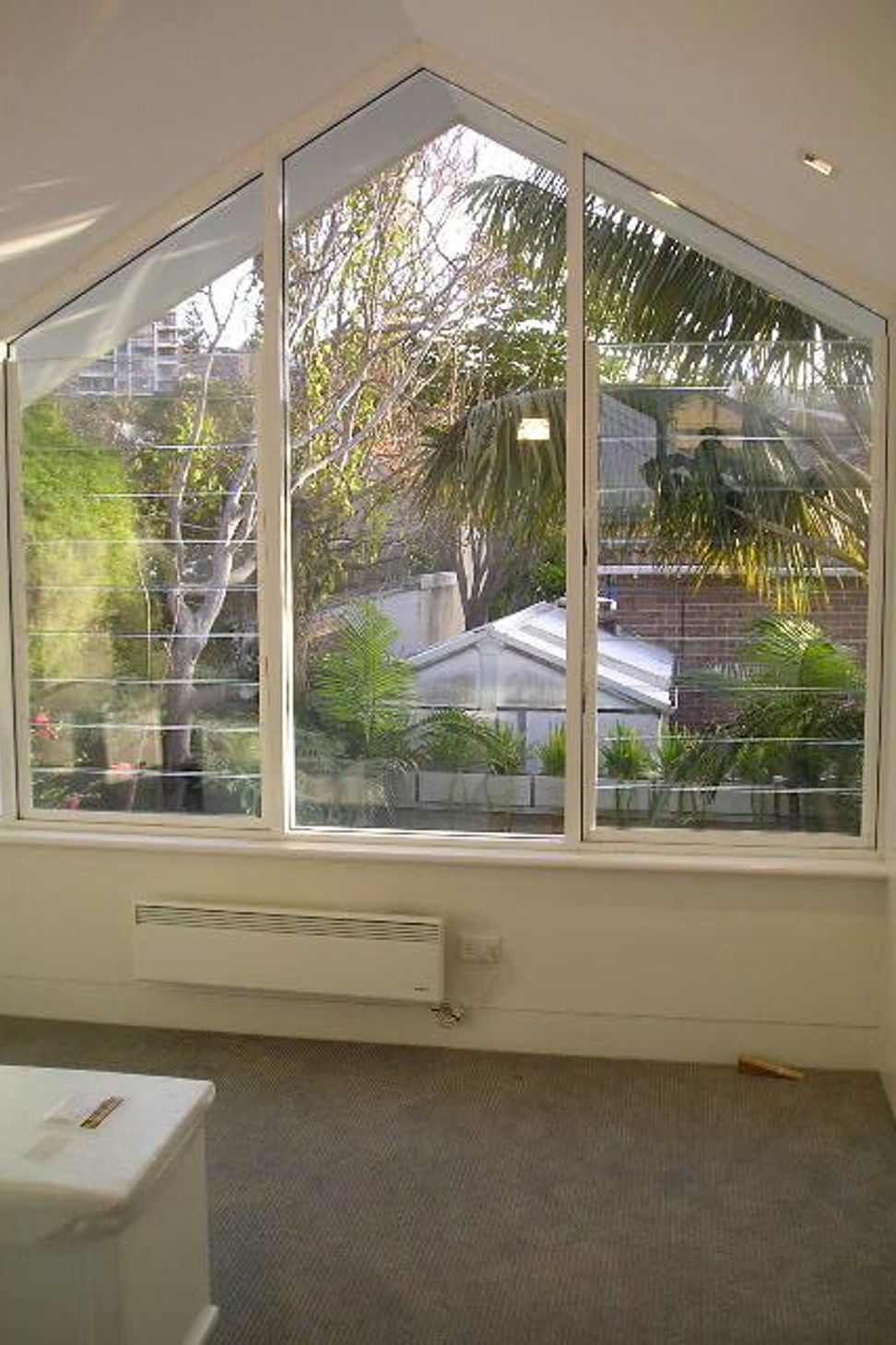 Upper level bedroom looking out over yard