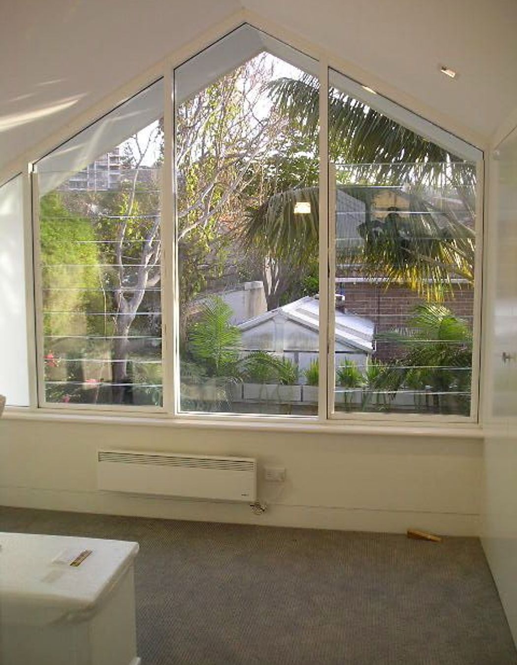 Upper level bedroom looking out over yard
