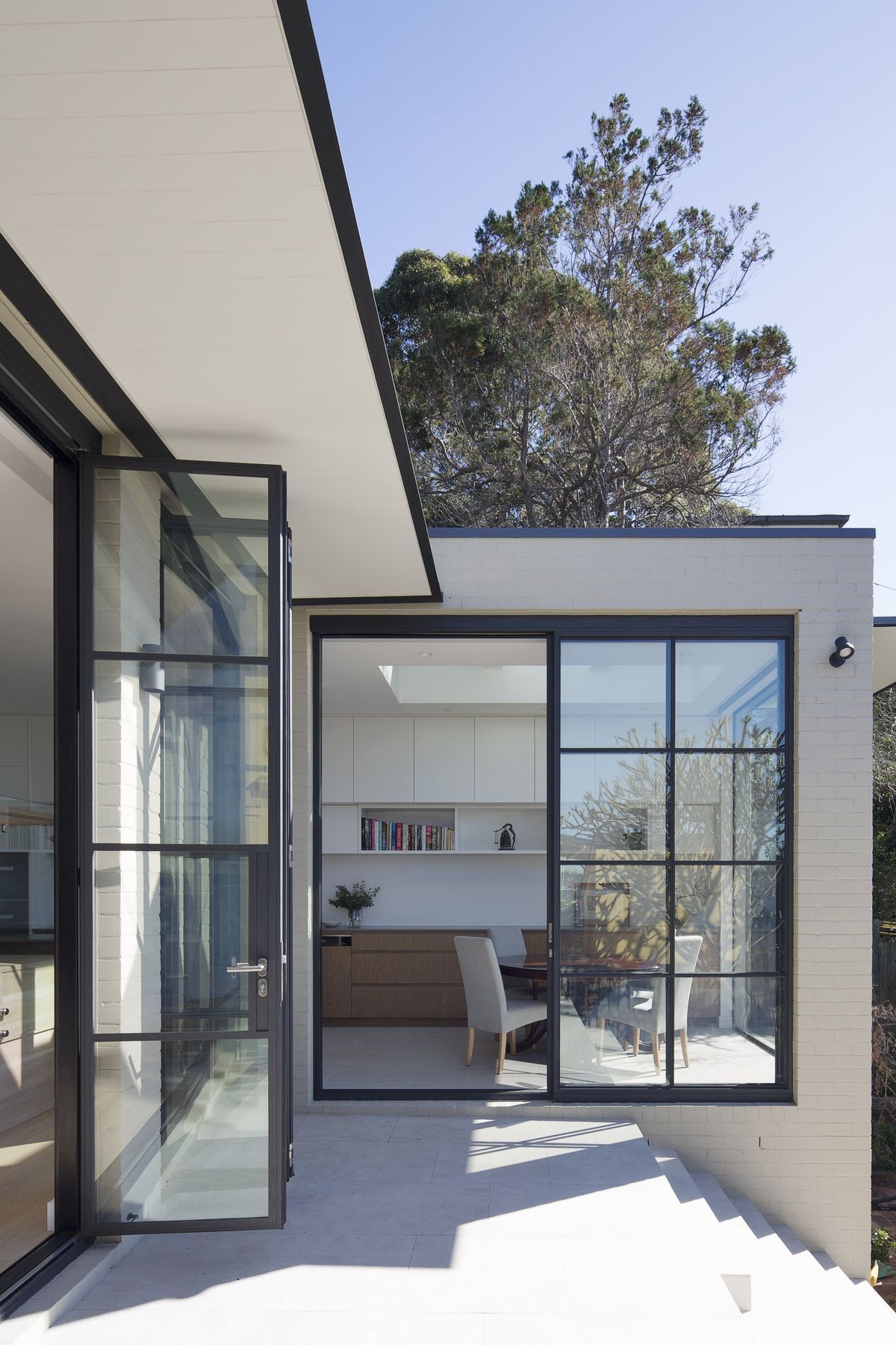 Bespoke black steel doors to frame all views of the rear extension.