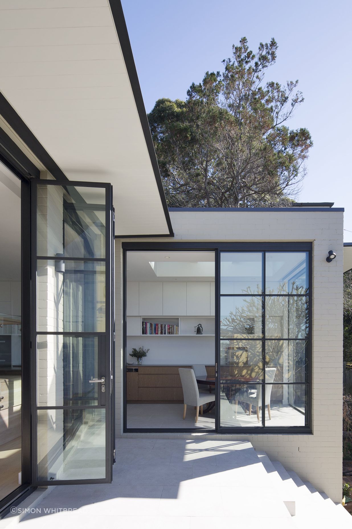 Bespoke black steel doors to frame all views of the rear extension.
