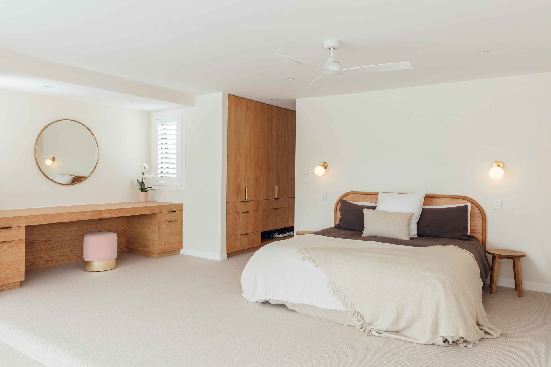 The main bedroom is a study in refined elegance with a muted colour palette teamed with timber and brass accents.
