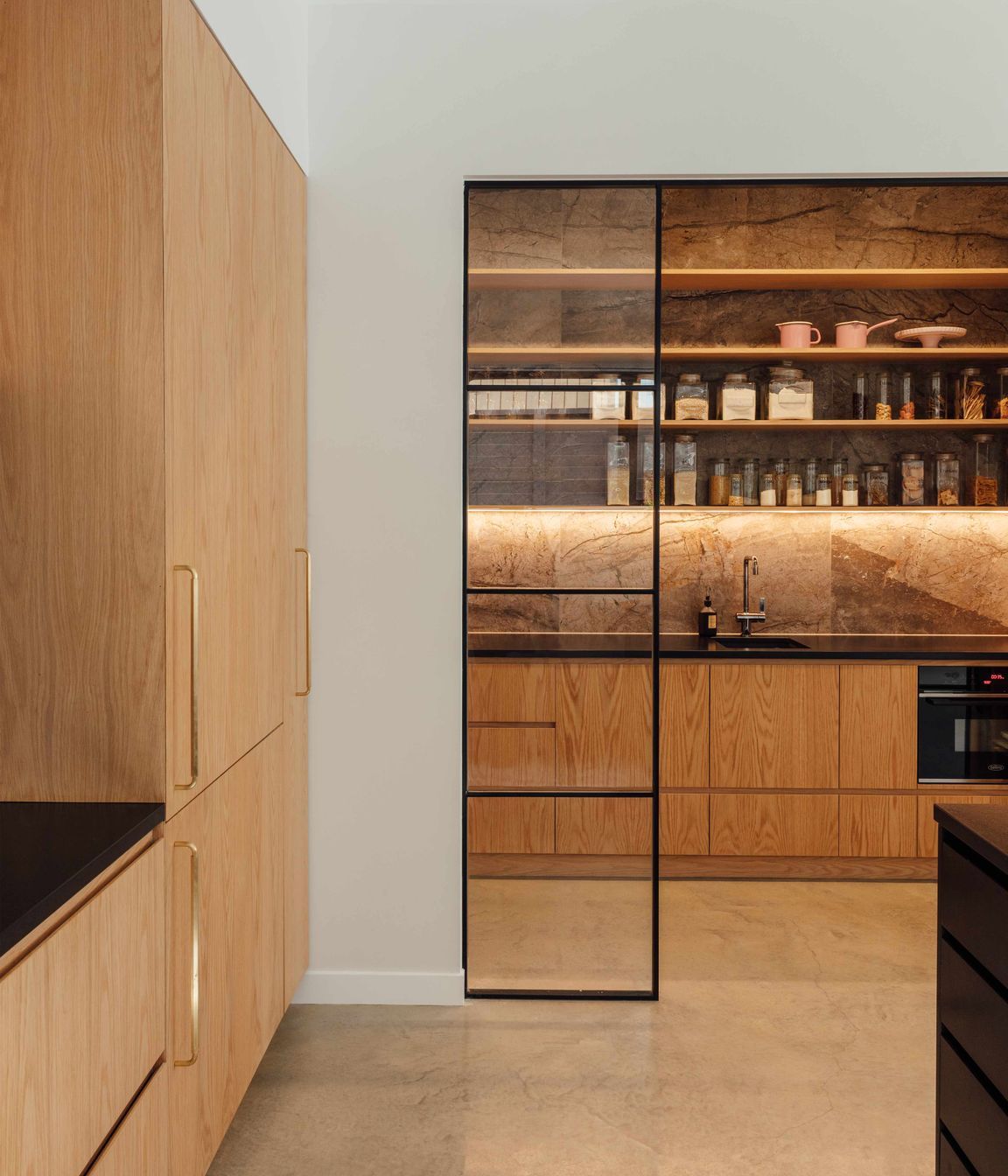 The butler’s pantry has the toaster, jug and blender on one side—to contain the morning mayhem—and a wine and cocktail making station on the other.