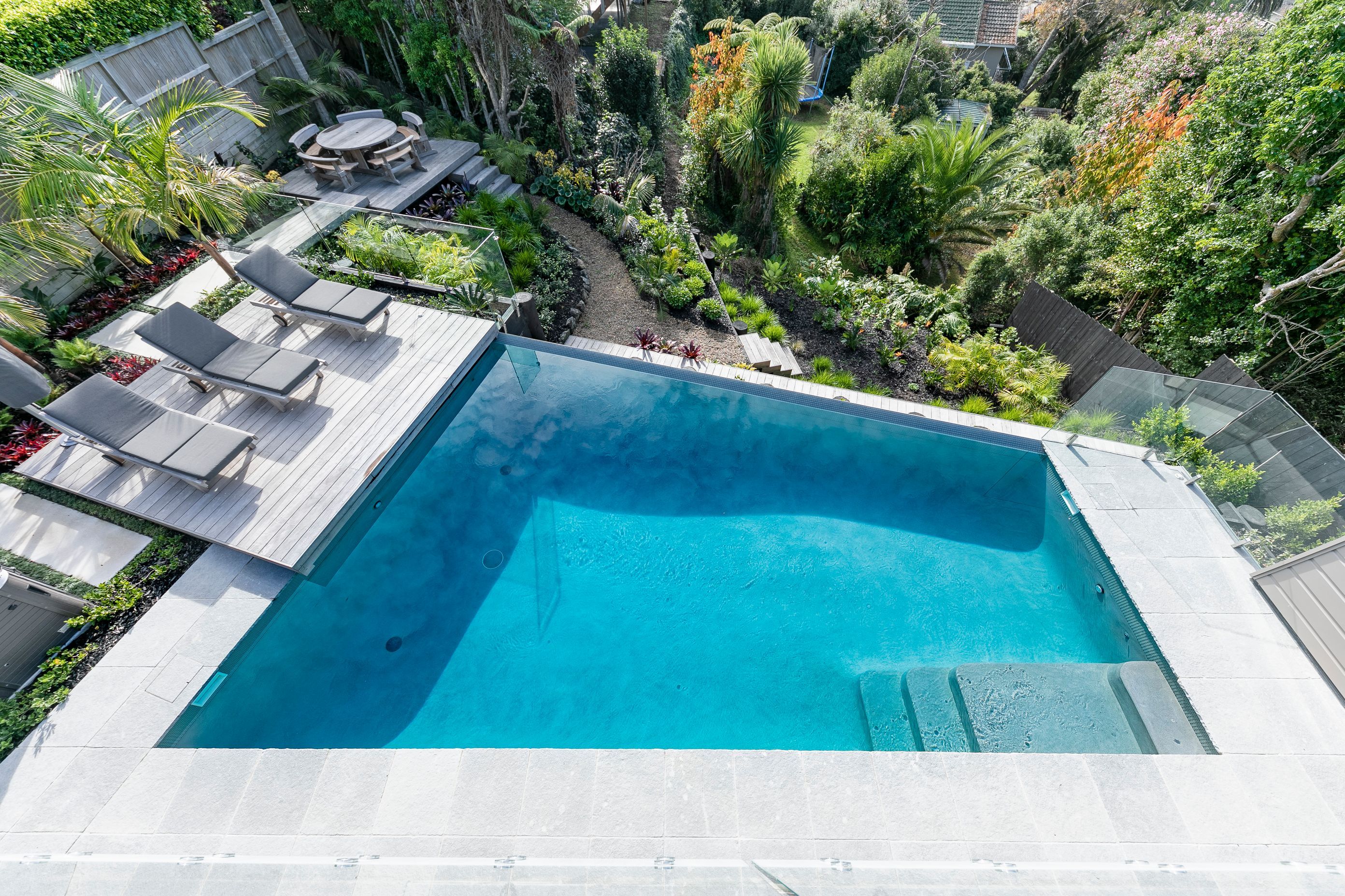 Antique Sky Limestone Coping & Pavers from Timeless Stone, Hydrazzo Hatteras Gray Pool Plaster from SSL Distributors