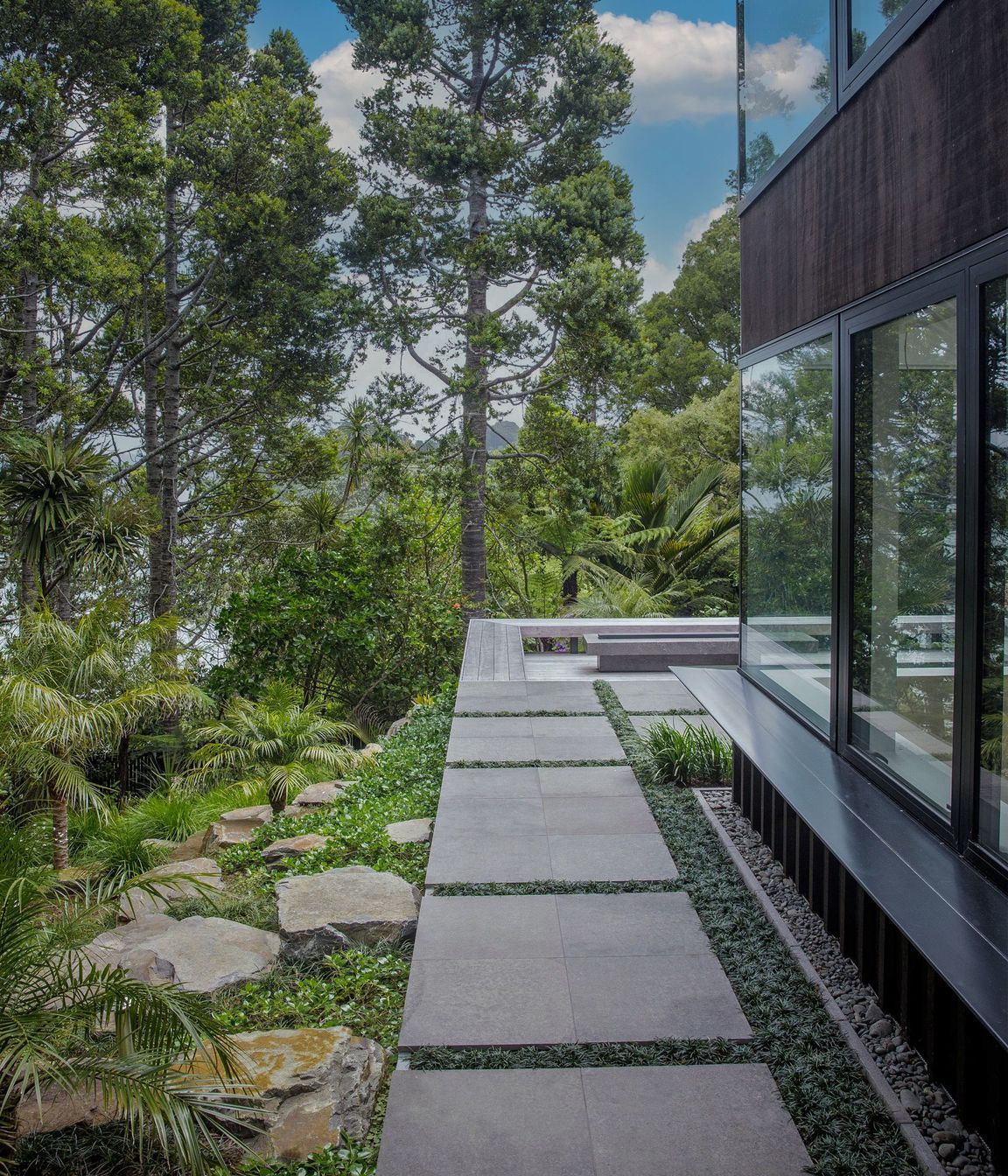 Stone paved side path, hardwood deck and fire pit.