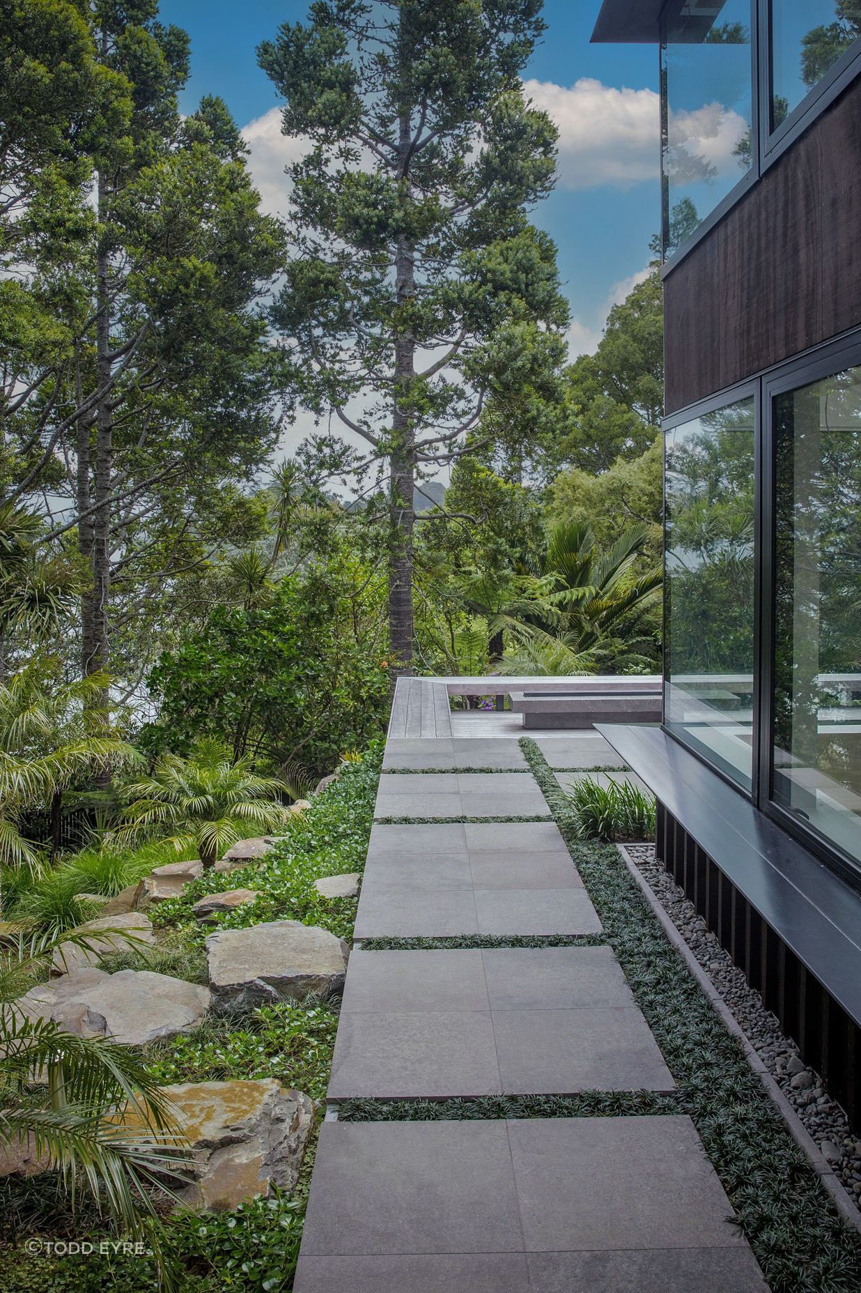 Stone paved side path, hardwood deck and fire pit.