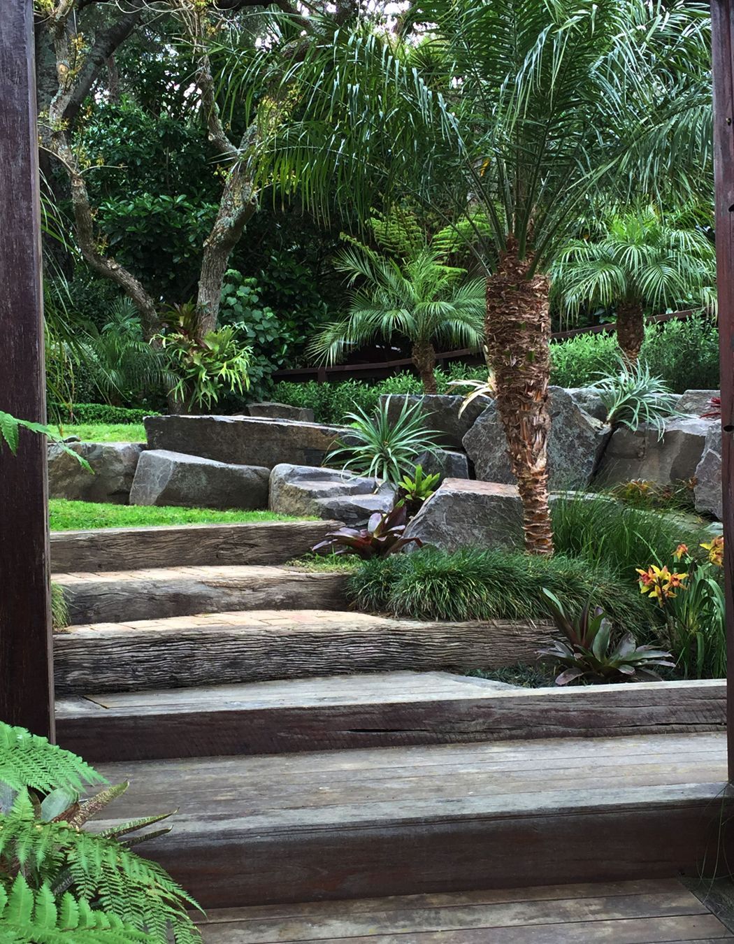 Rock retaining, hardwood sleeper steps and subtropical/native plantings