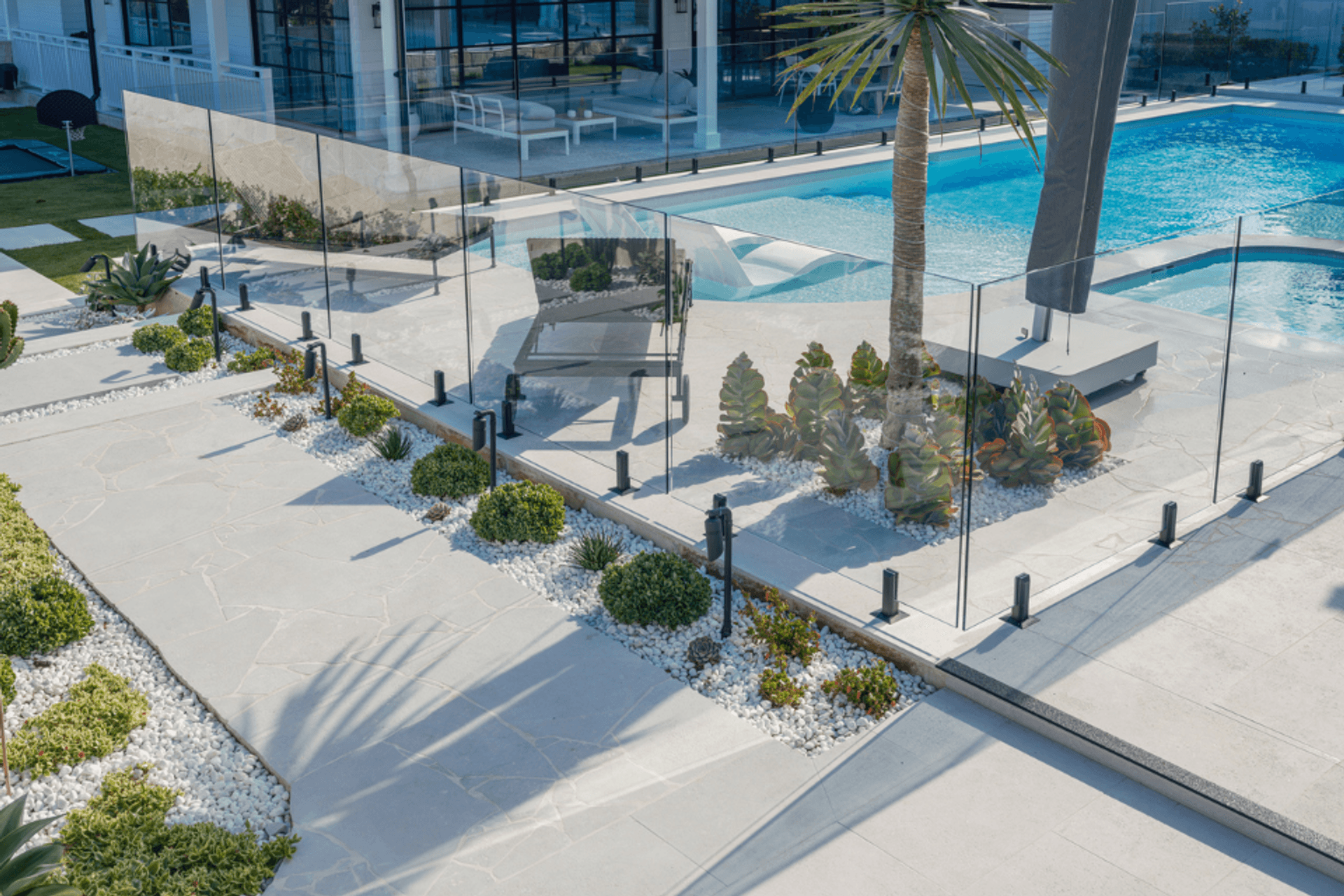 Luna Chiaro Limestone in large format slabs creates bold, uninterrupted surfaces throughout the entertaining areas. Combined with crazy paving in the garden beds, the stone provides both architectural structure and natural softness—all from one material.