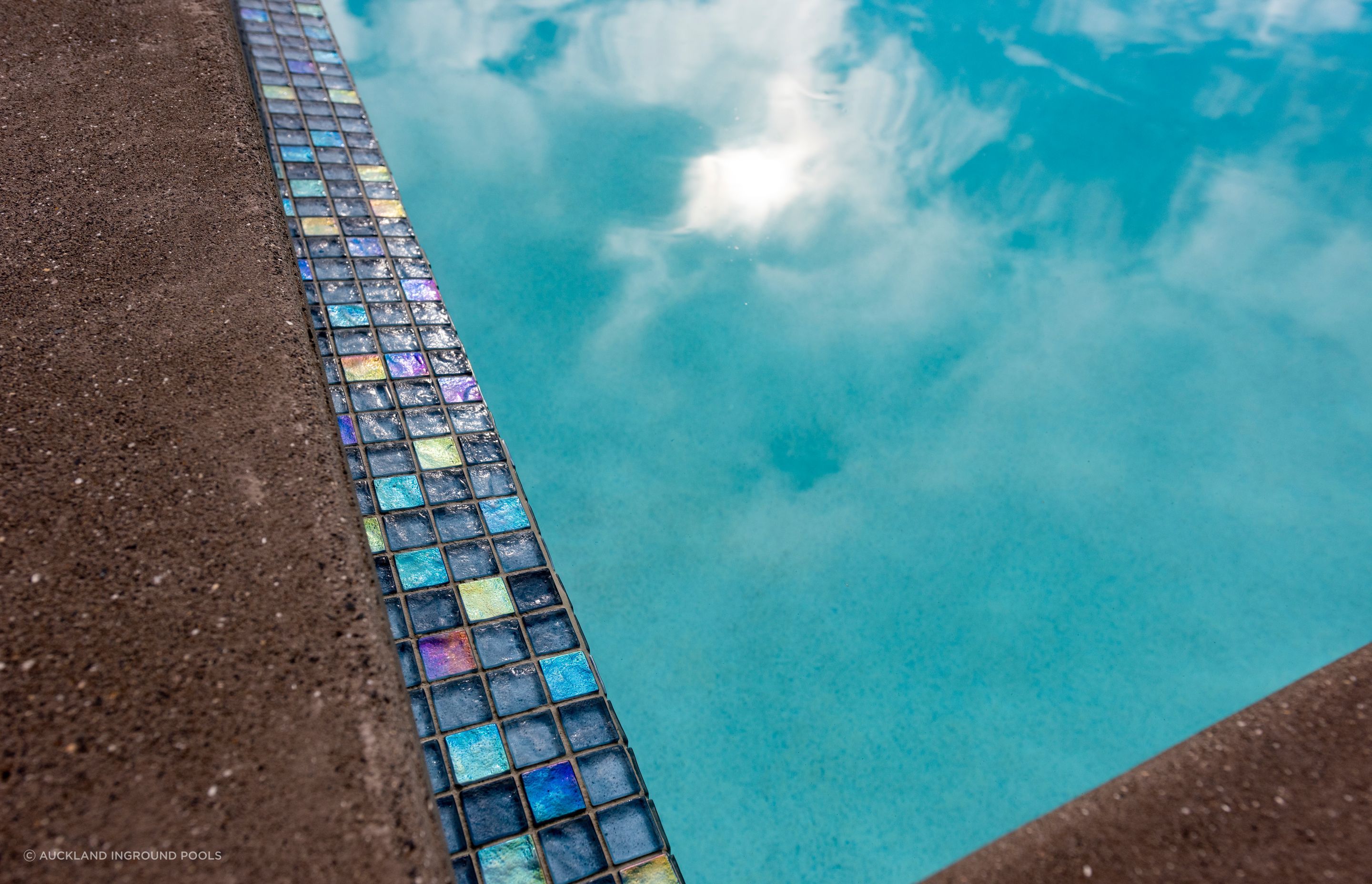 The Palmer & Allen Tiles used for the pool waterline and horizon edge can look very different across the space of the day, depending on how the sunlight captures them