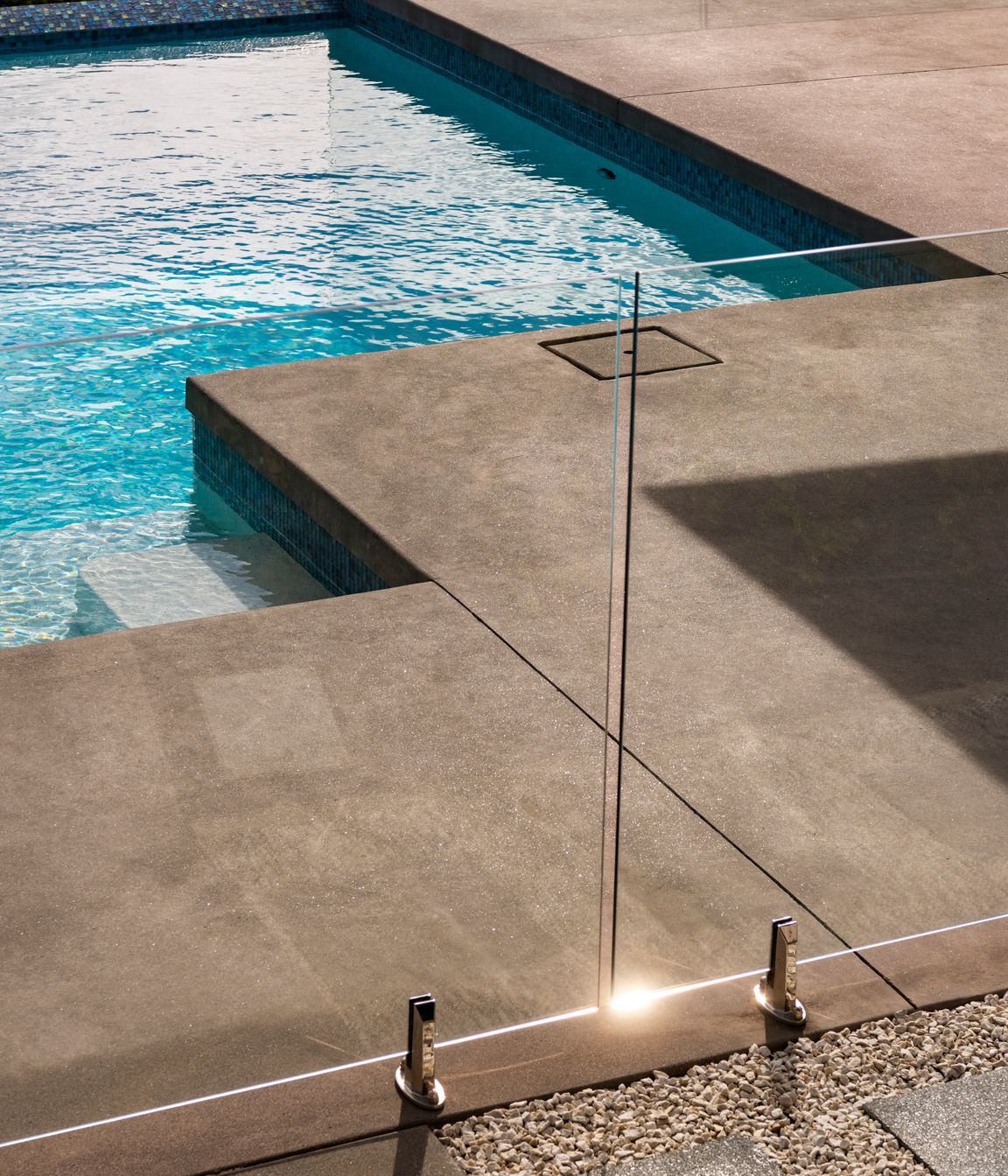 The homeowner opted for a poured concrete finish right to the pool edge