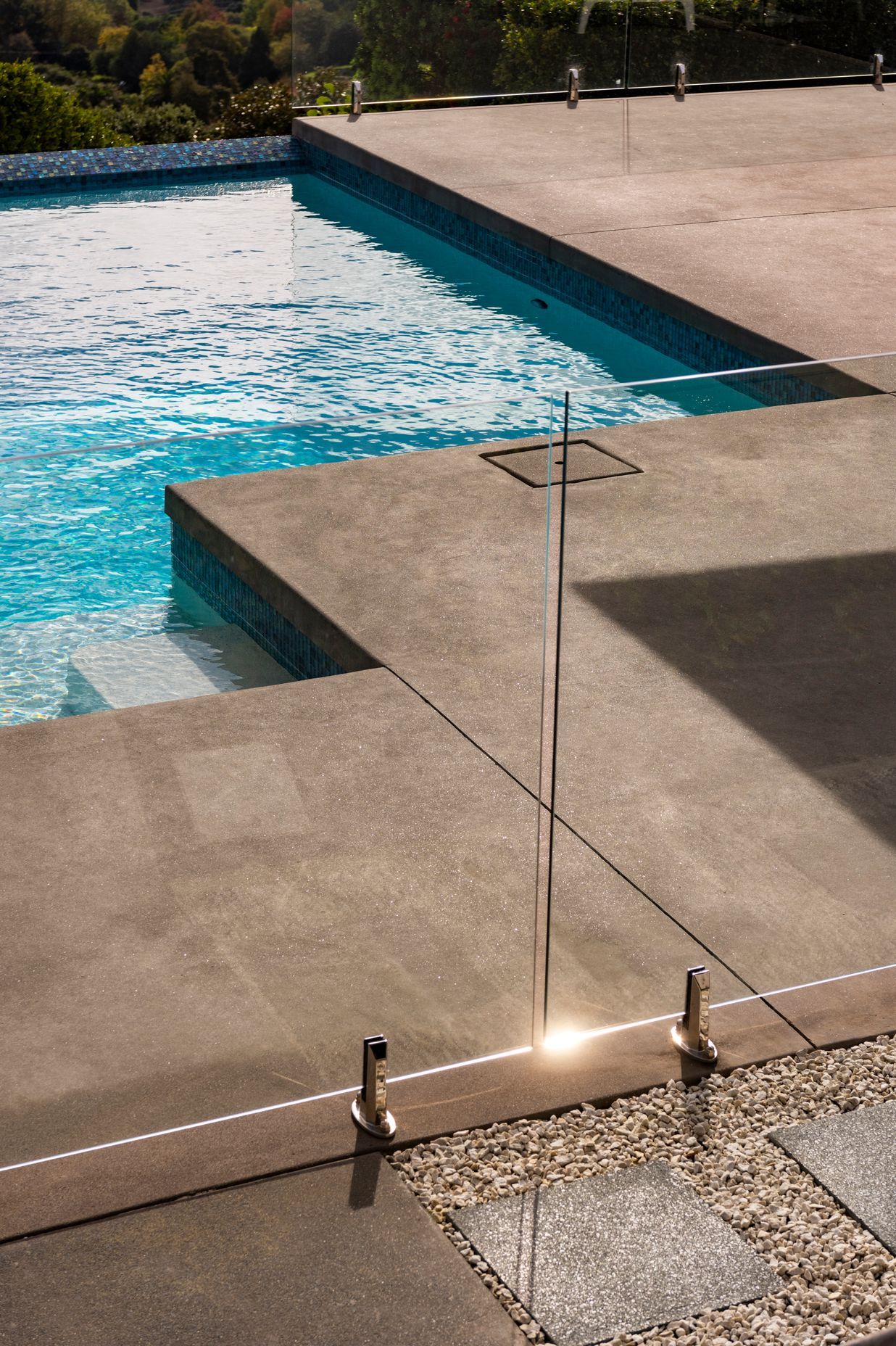 The homeowner opted for a poured concrete finish right to the pool edge