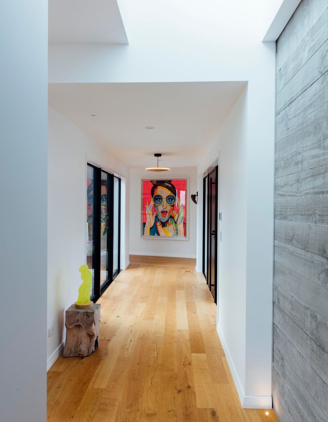 A painting by homeowner at the end of the hallway is based on artwork used on the bottle of the couple's favourite champagne: Gardet Raphael Laventure rosé.