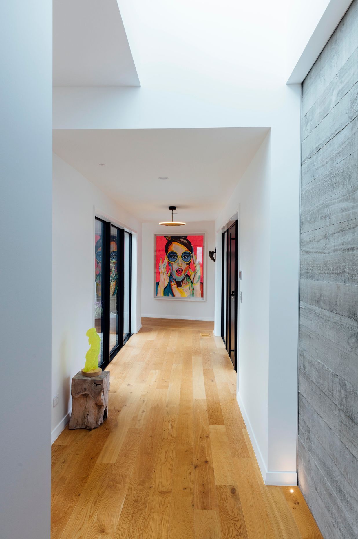 A painting by homeowner at the end of the hallway is based on artwork used on the bottle of the couple's favourite champagne: Gardet Raphael Laventure rosé.