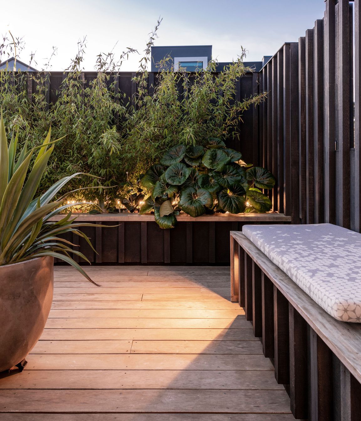 Subtle lighting integrated into the furniture and timber screens adds atmosphere