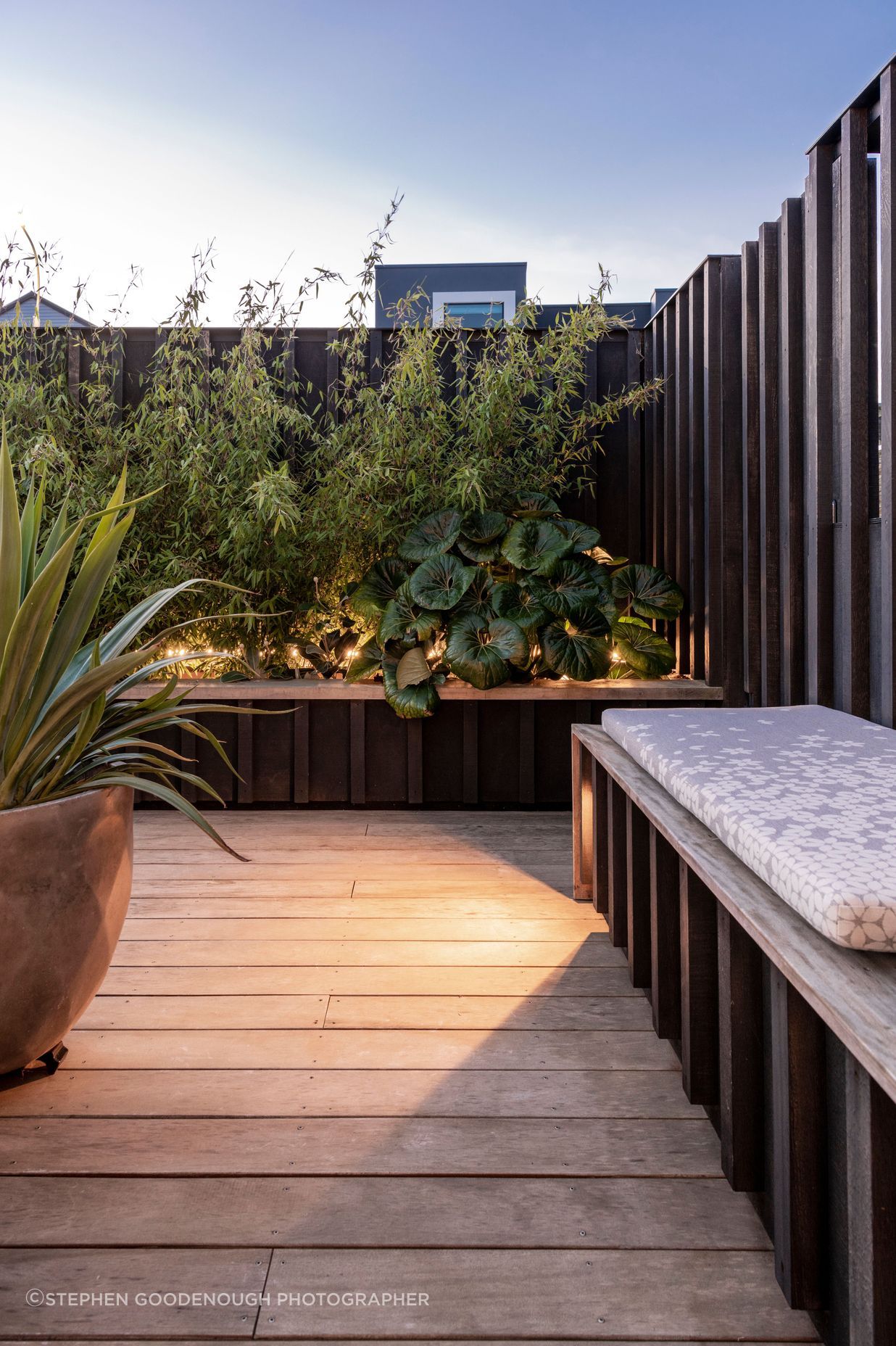 Subtle lighting integrated into the furniture and timber screens adds atmosphere