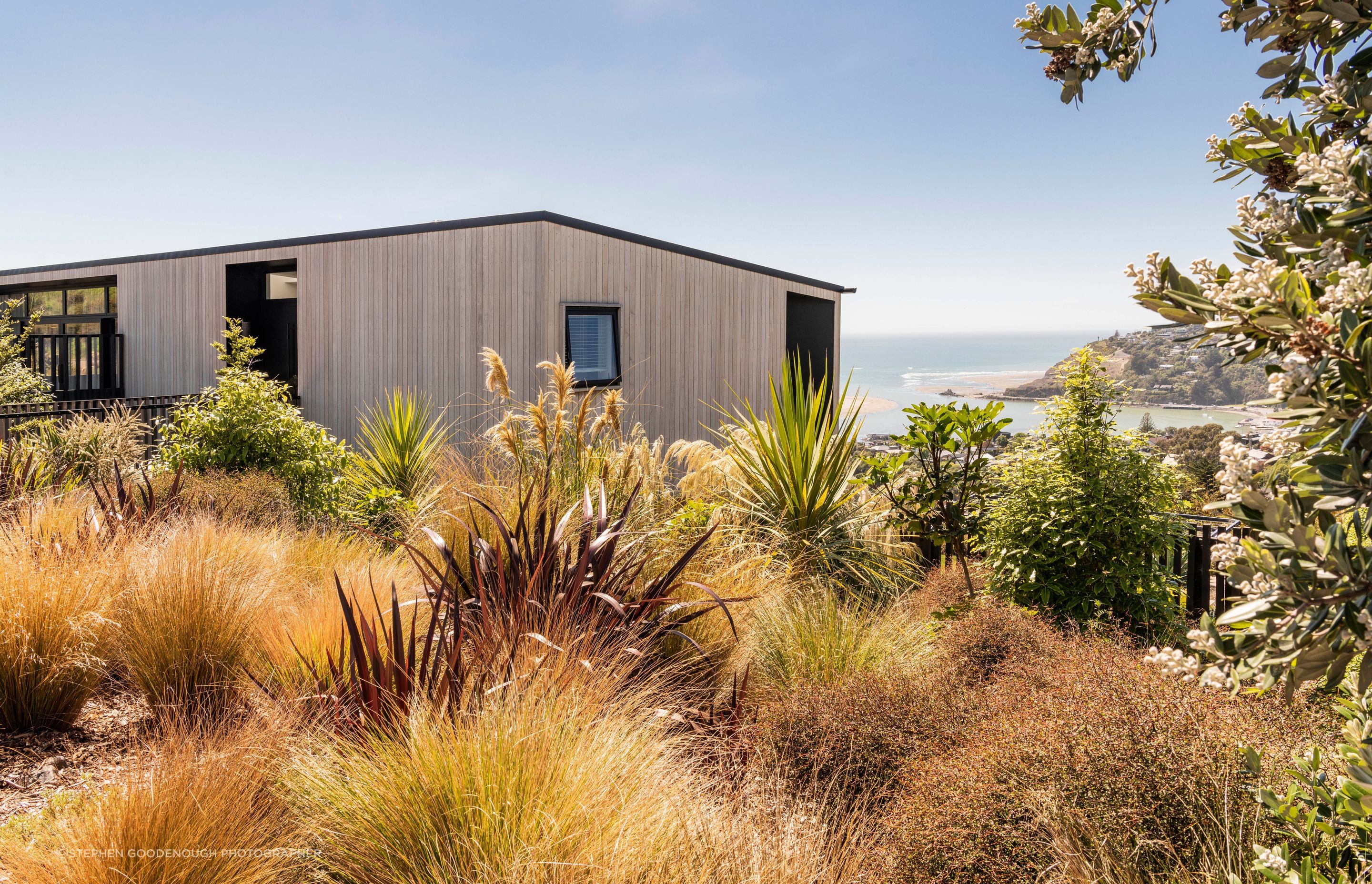 A naturalistic planting of tough Canterbury natives wrap around the street side of the house