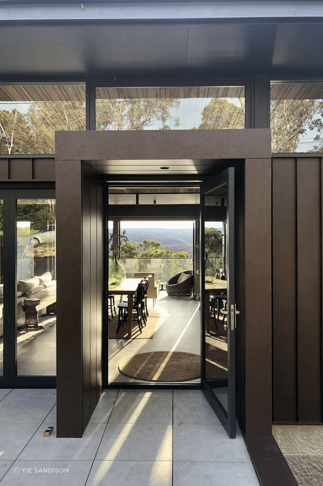 The corten entry portal transports you to a world of green and peace.