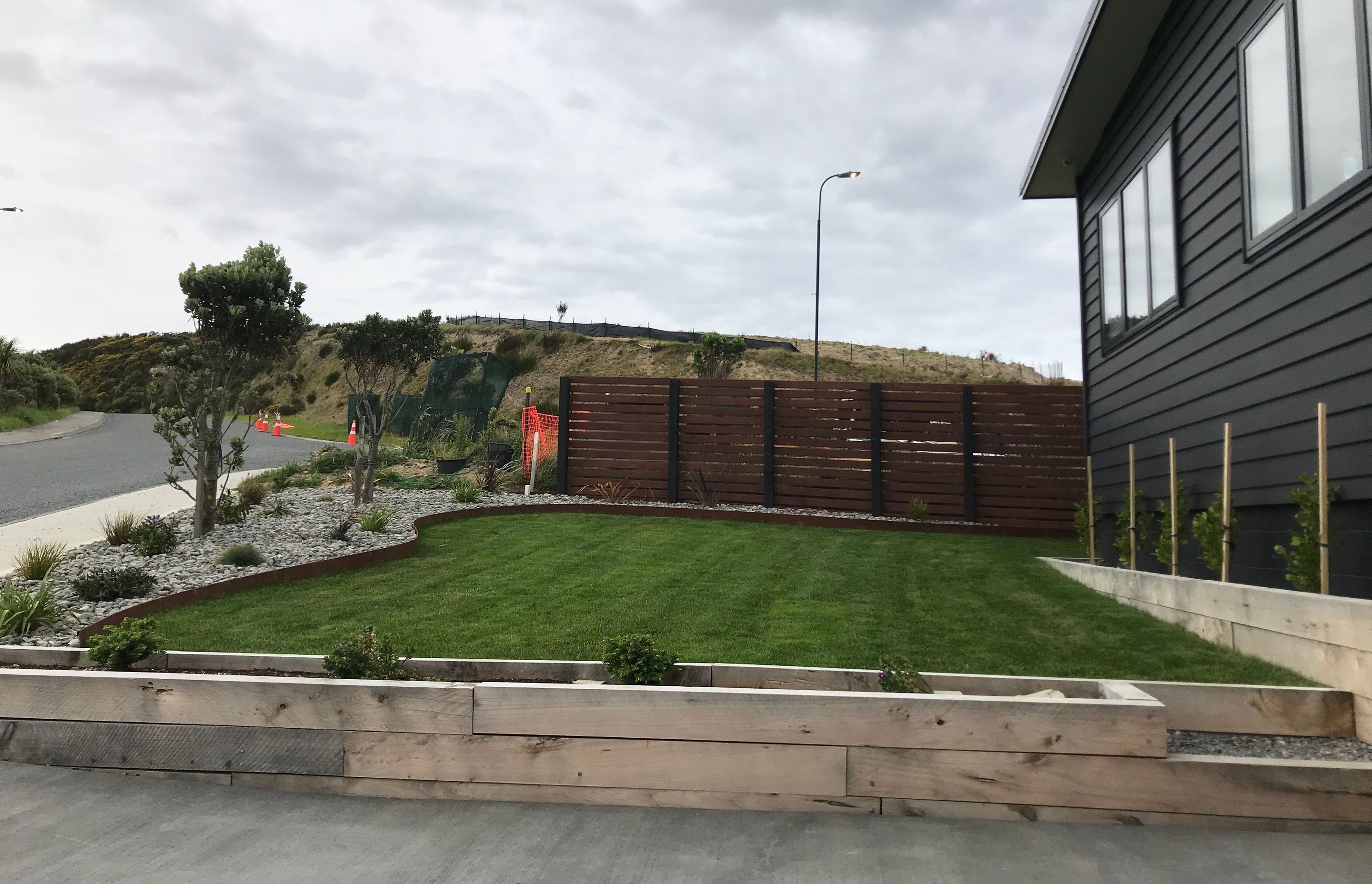 A rich patina finish of the weathering steel compliments the lush green grass of the section.