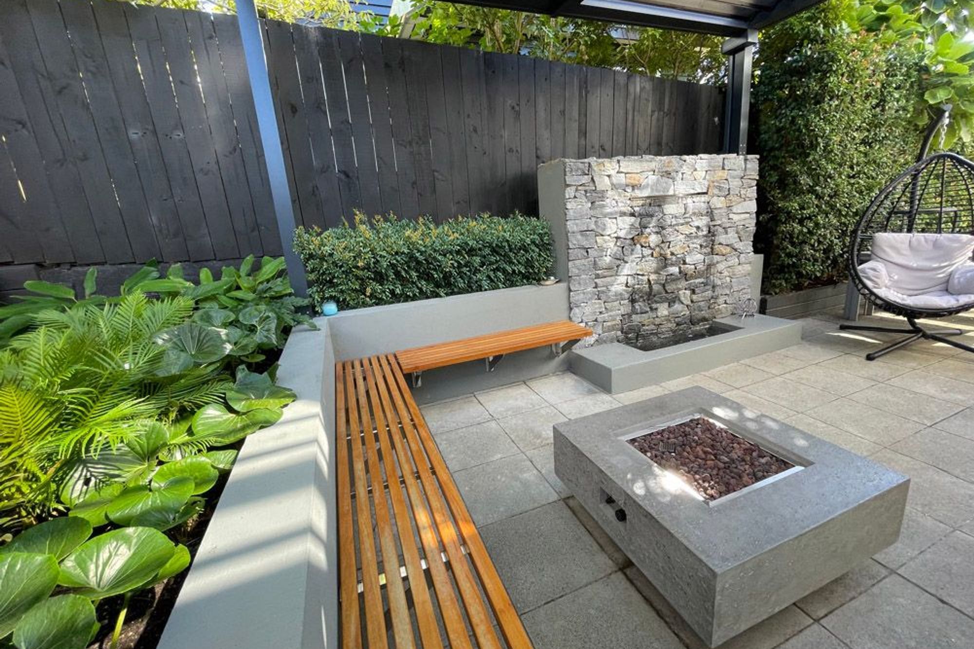 Covered patio with fire pit and water feature
