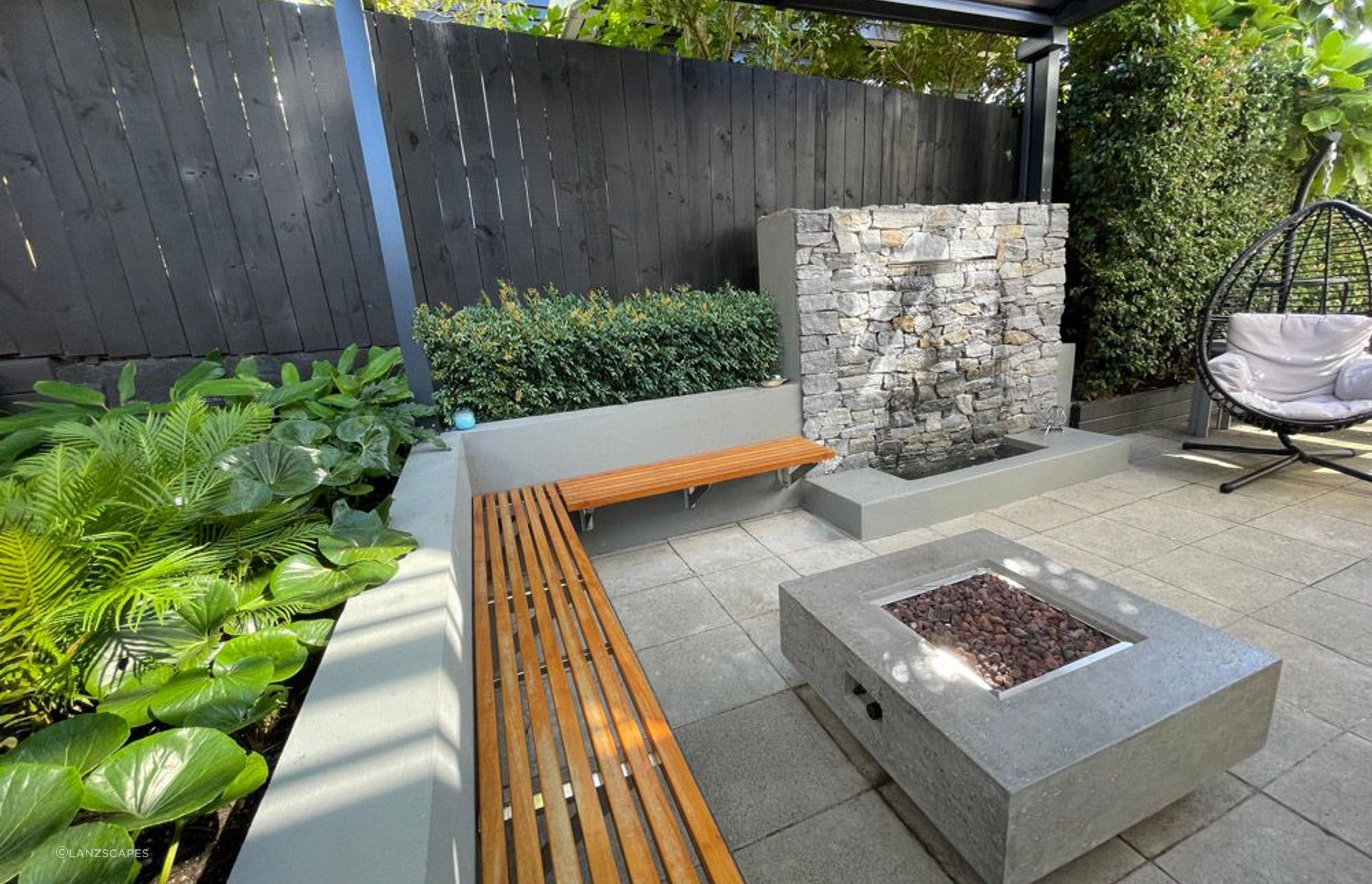 Covered patio with fire pit and water feature