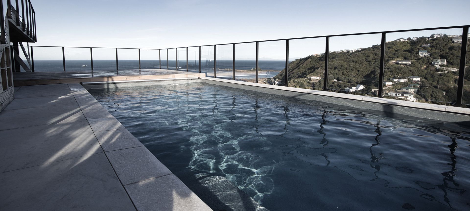 Hillside pool above Wellington banner